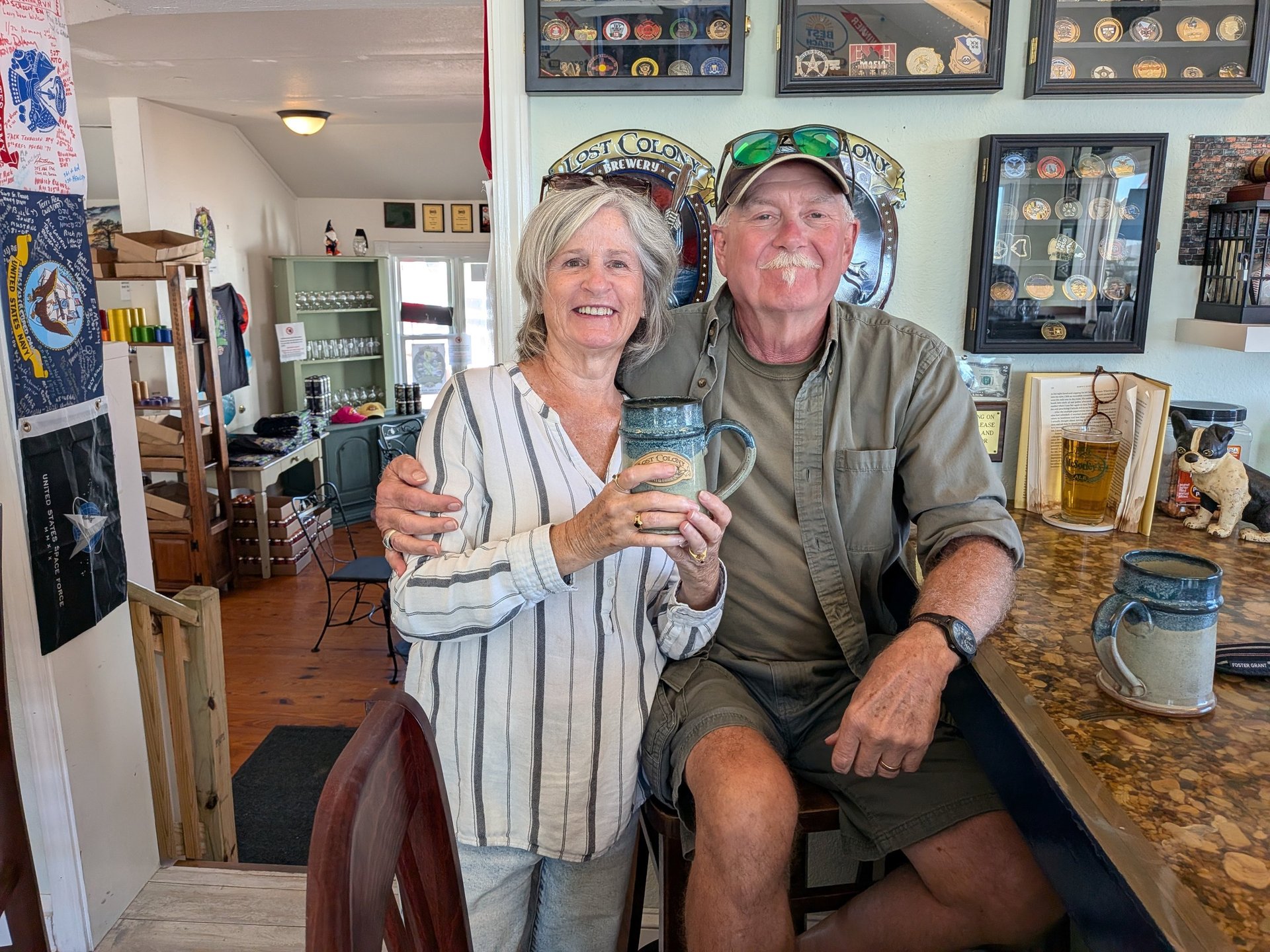 Maggie and Pete sitting at the bar with their special mugs