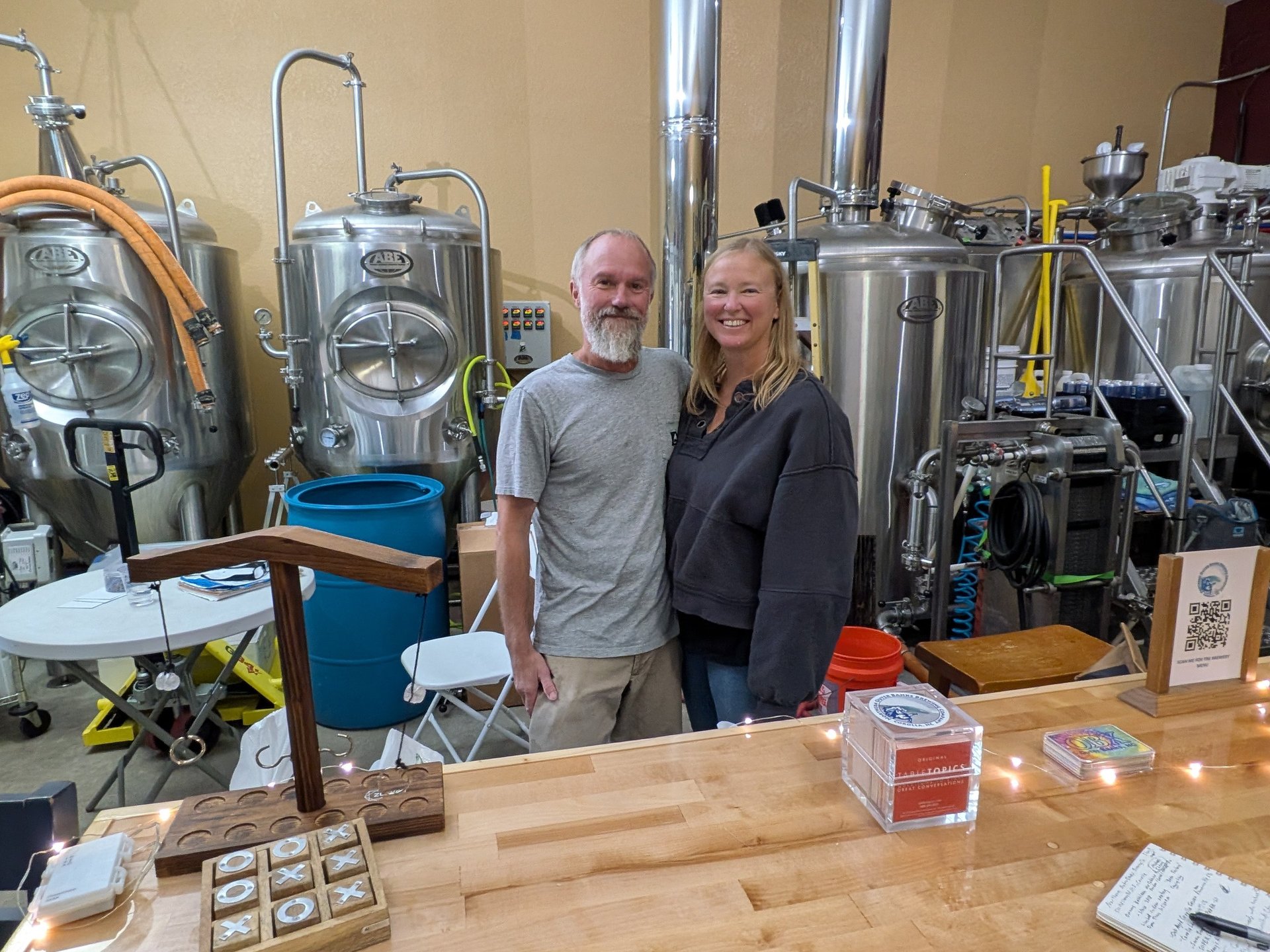 michael and kathleen cherry standing in front of brewing tanks