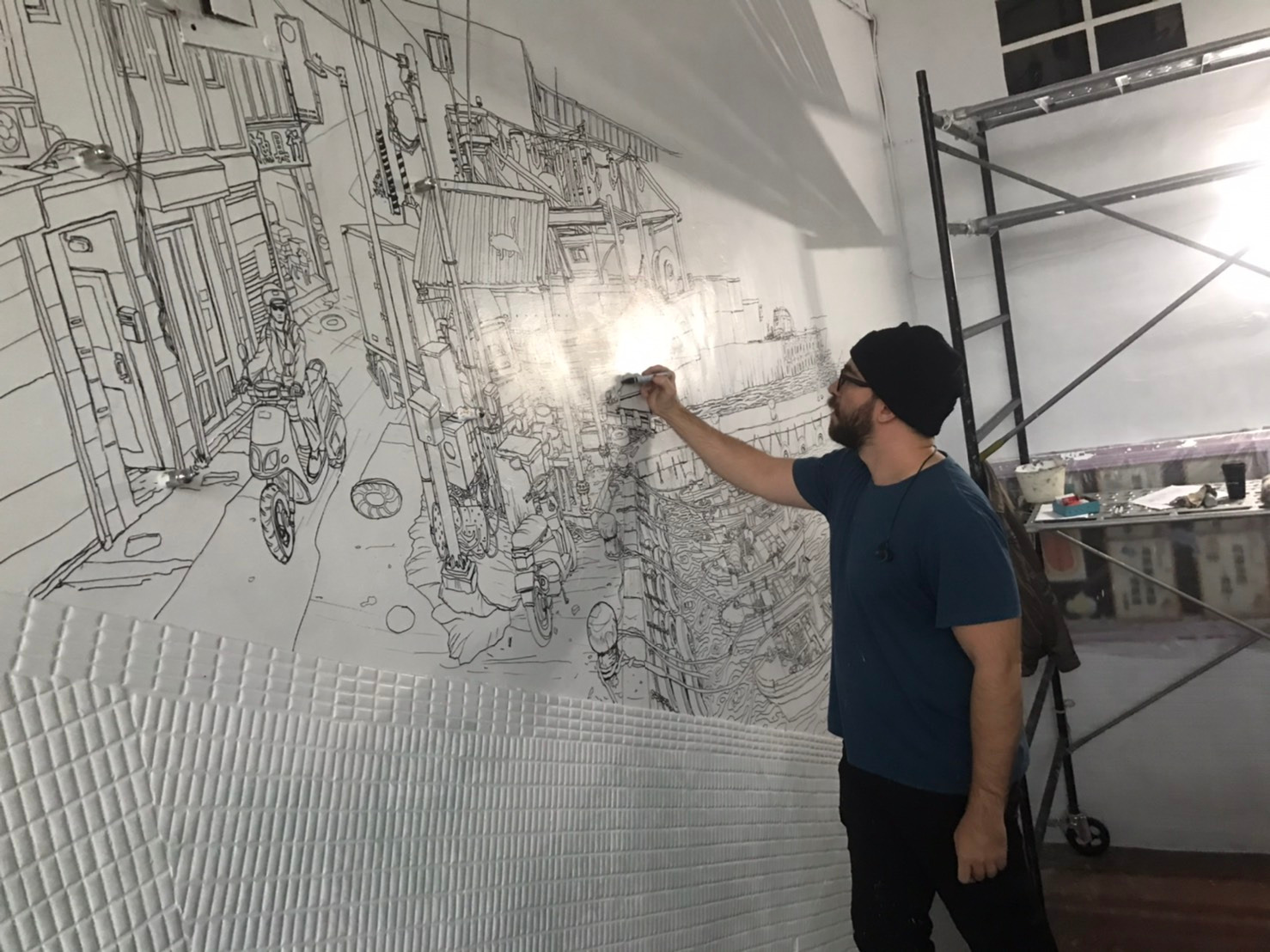 artist Evgeny Bondarenko sketching mural in Taiwan school