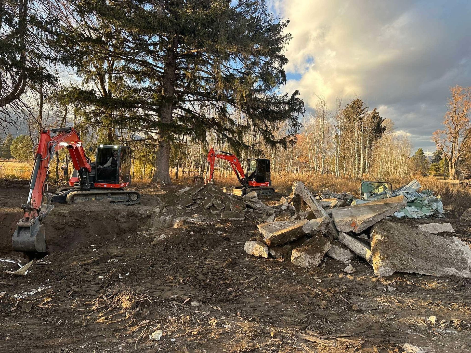 Kubota excavators digging up concrete