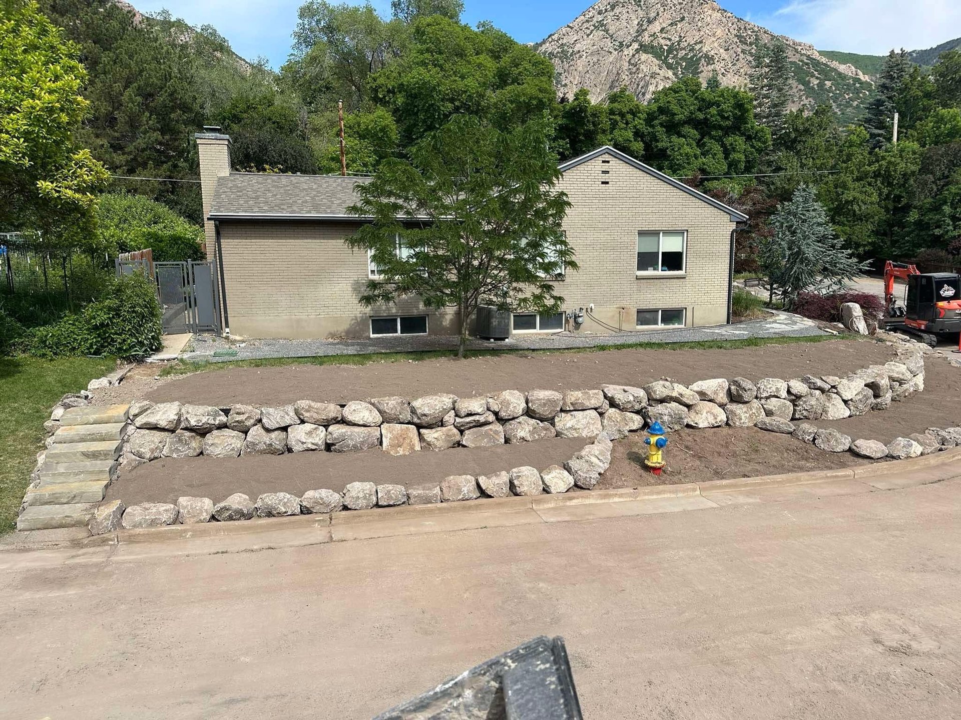 boulder wall and graded dirt at residential home