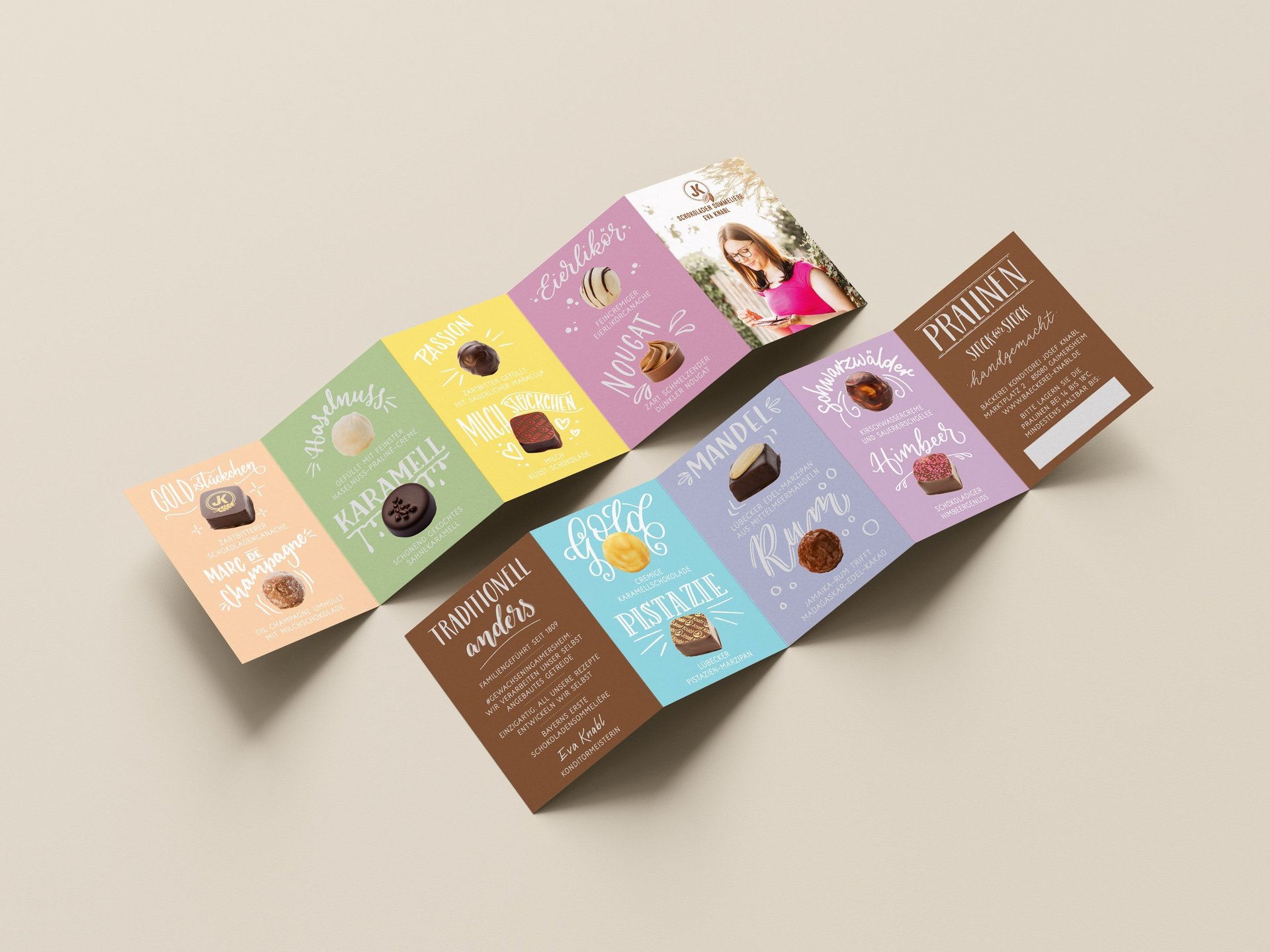 A colorful accordion-fold chocolate menu showcasing gourmet pralines, including pistachio and champagne truffles.