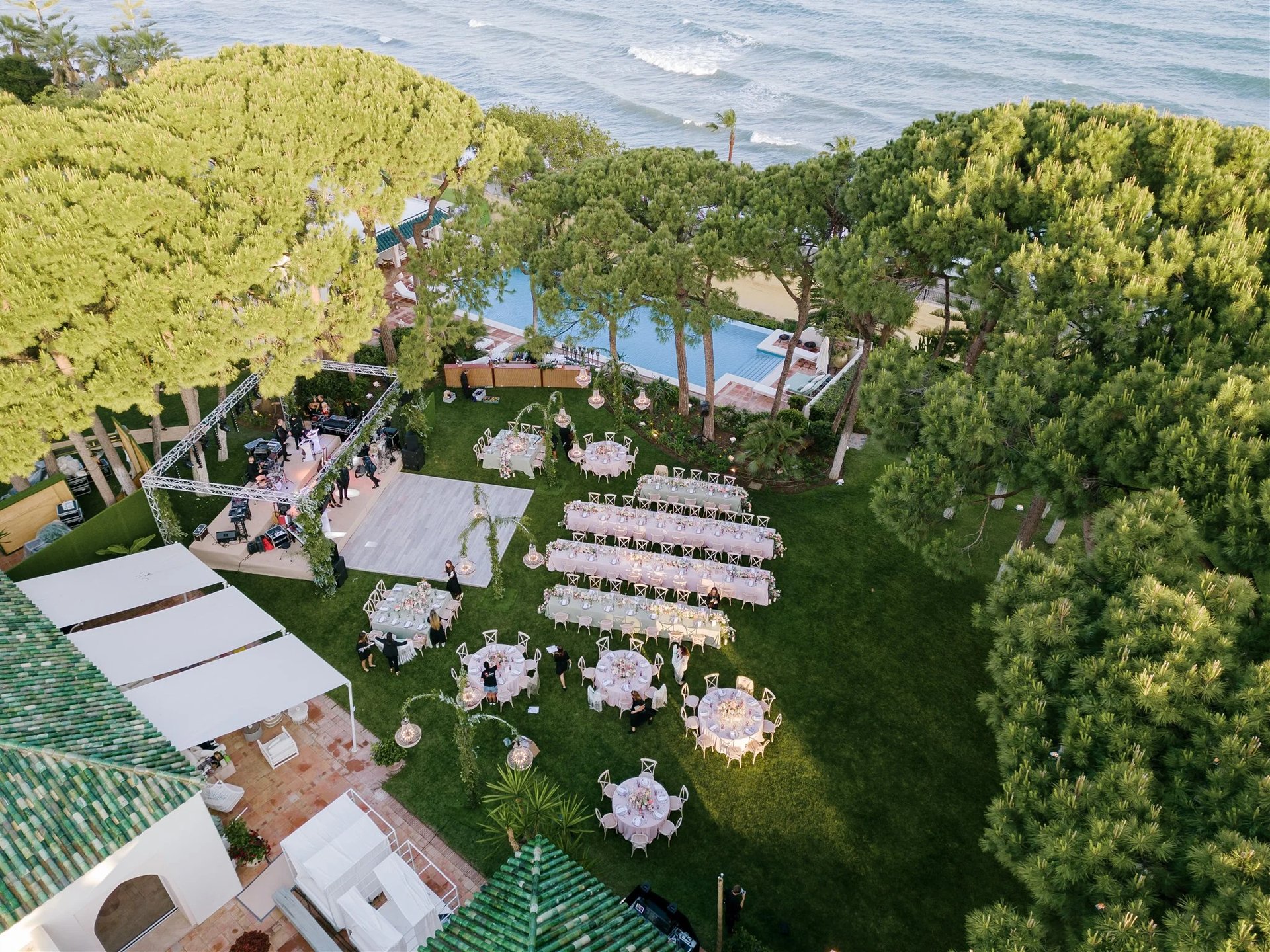 Aerial view of beachfront wedding layout under pine trees