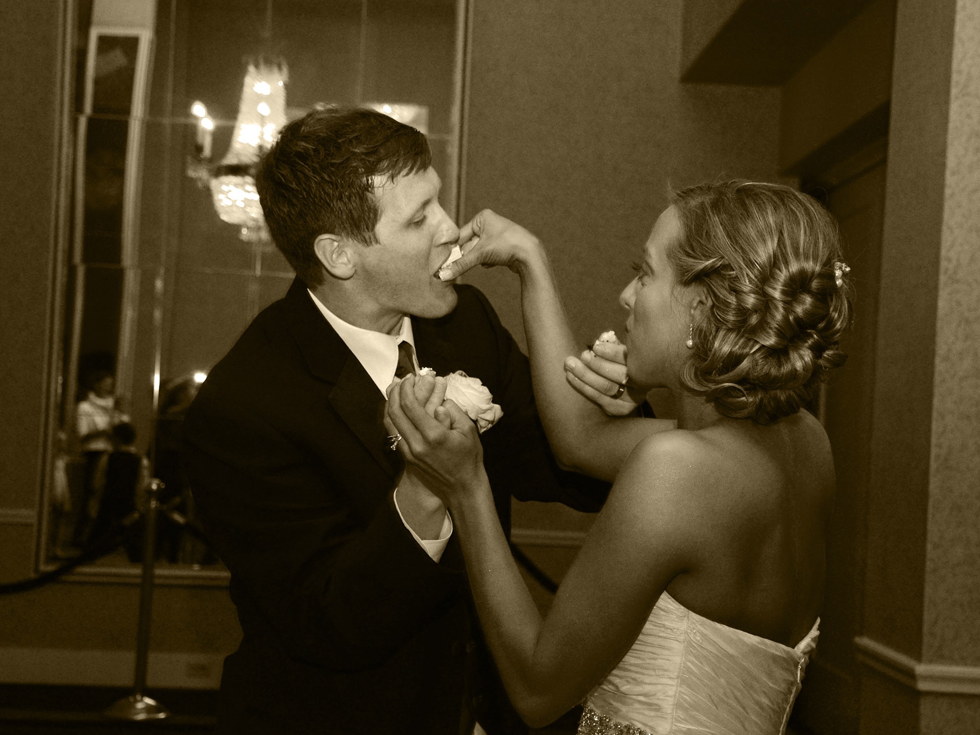 a bride and groom feeding each other a piece of cake