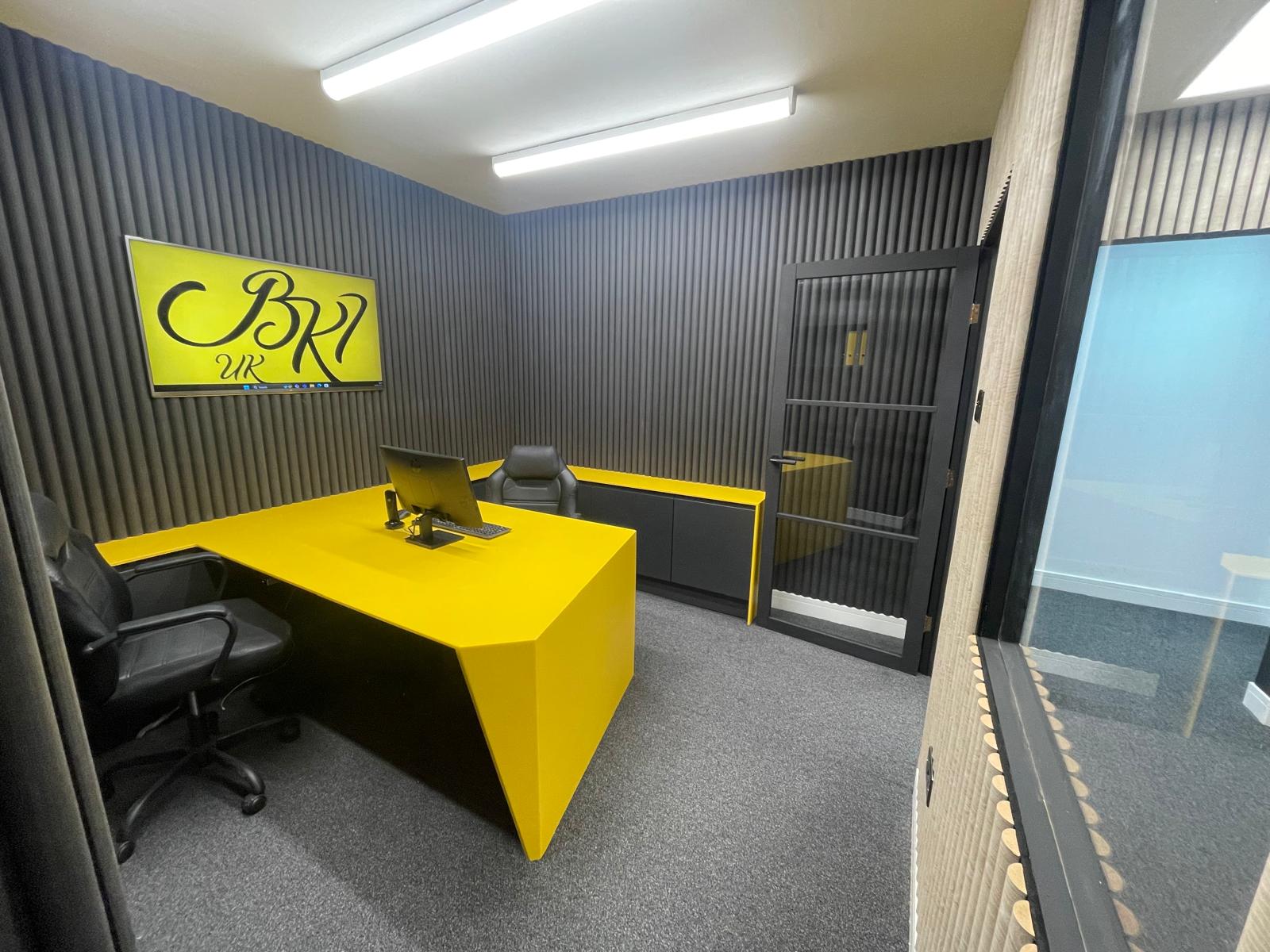 A modern office with sleek HIMACS surfaces and curved acoustic walls, blending style and function.