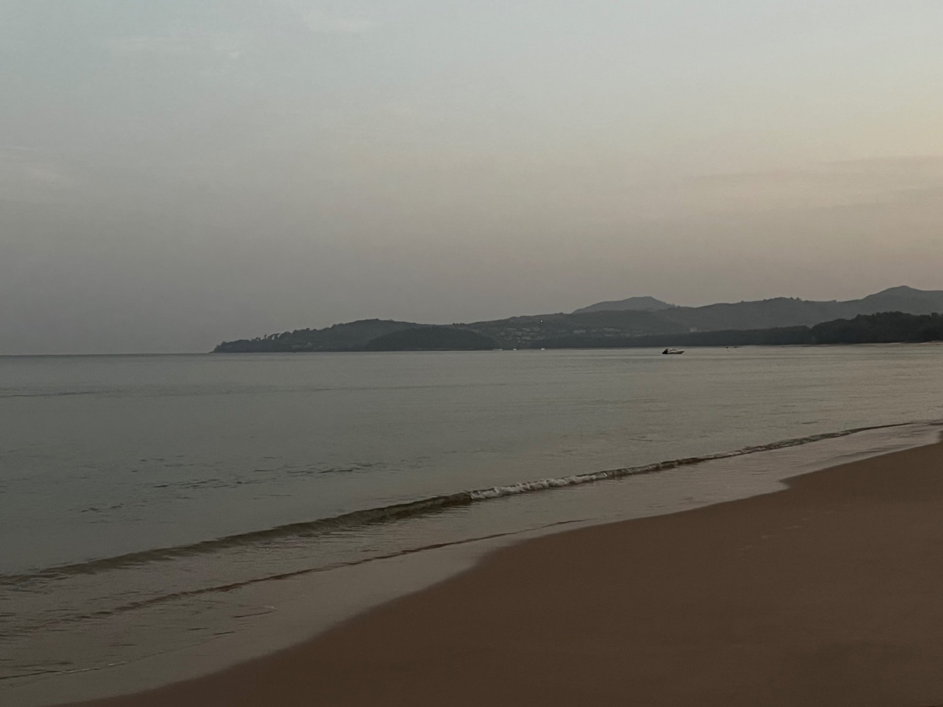 Bang Tao beach at sunrise with the mountains in the background