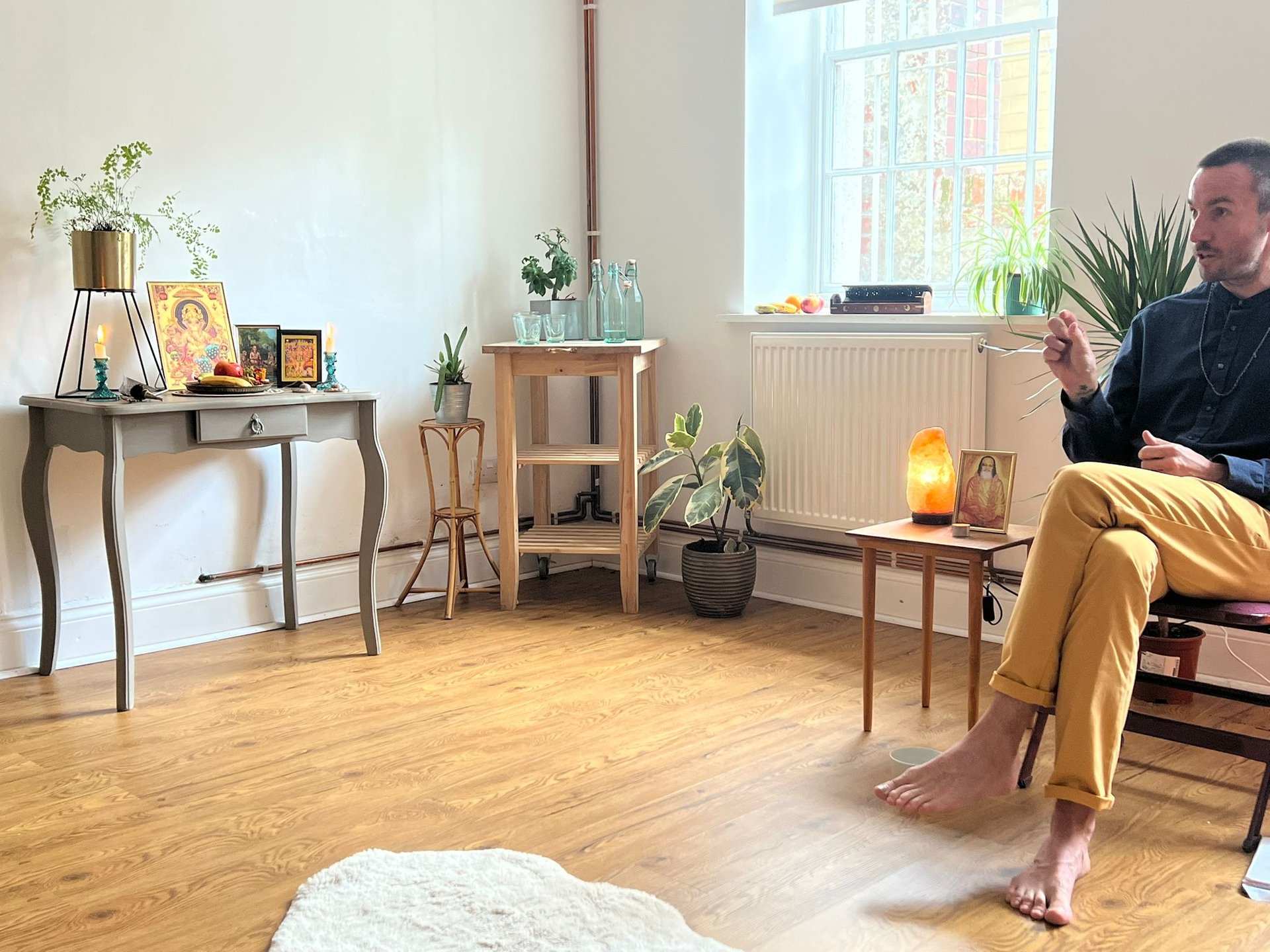 meditation teacher in yellow trousers and blue shirt