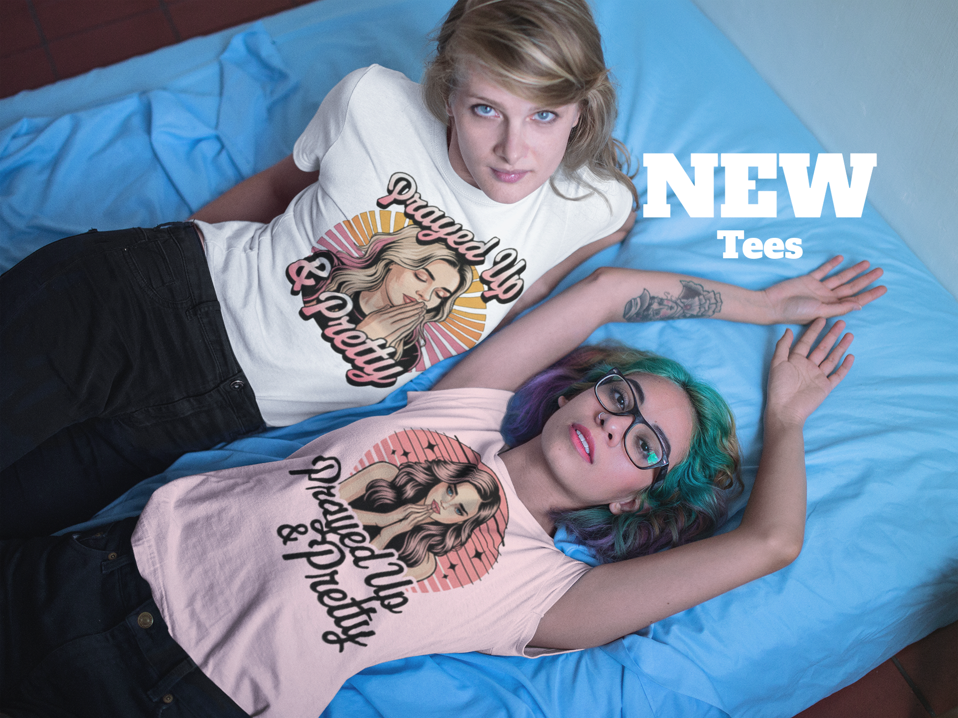 Two women wearing Prayed Up and Pretty graphic t-shirts from a new collection of apparel.