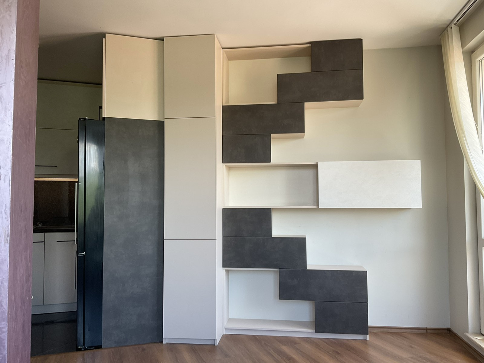 A photo with wall mounted furniture with open space and laminated doors in white and walnut brown