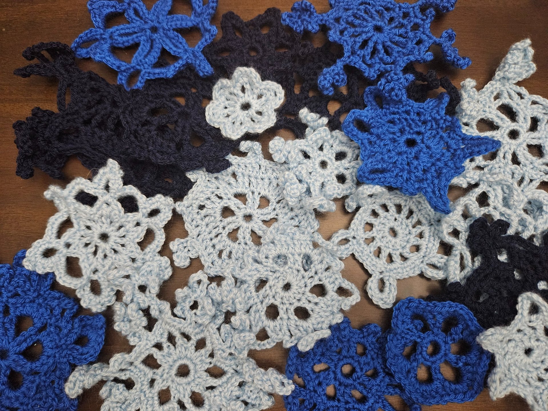 crochet snowflakes on a wooden table