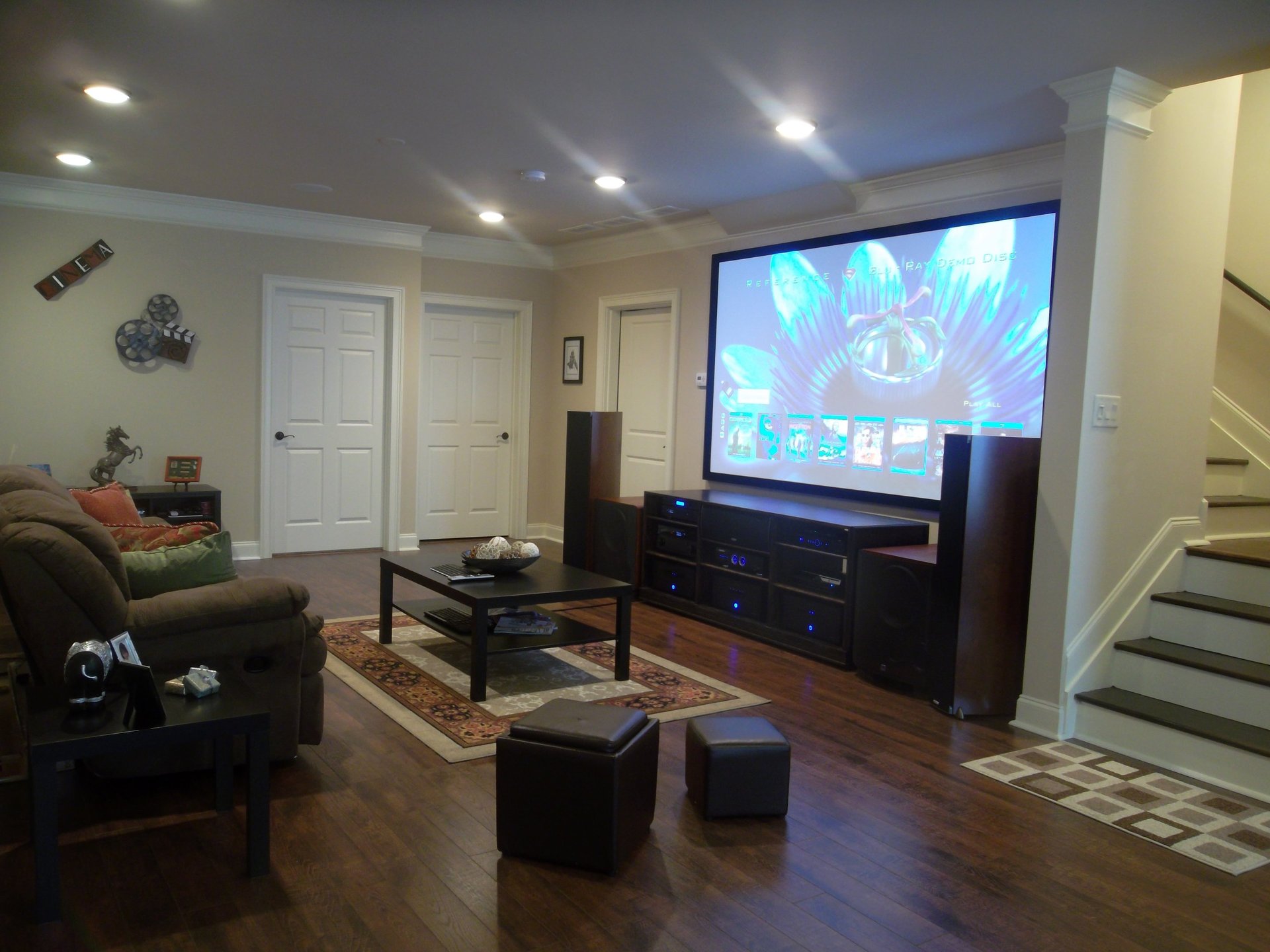 motorized projector screen installed in a luxury London living room with concealed ceiling mounting