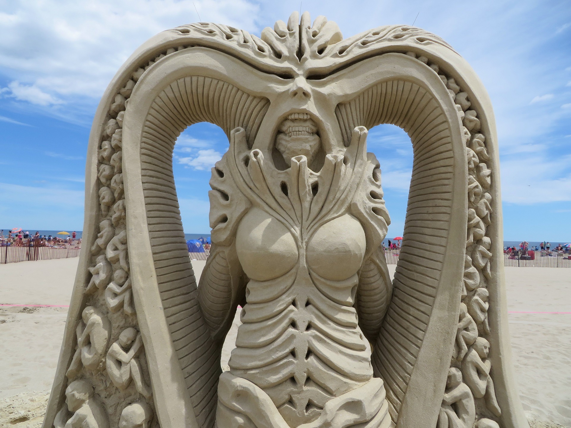 sand sculpture depicting a creature based on H.R. Giger artstyle