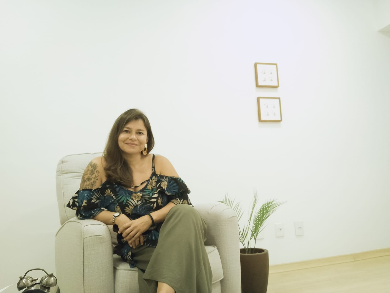a woman therapist sitting on a couch in a therapy room