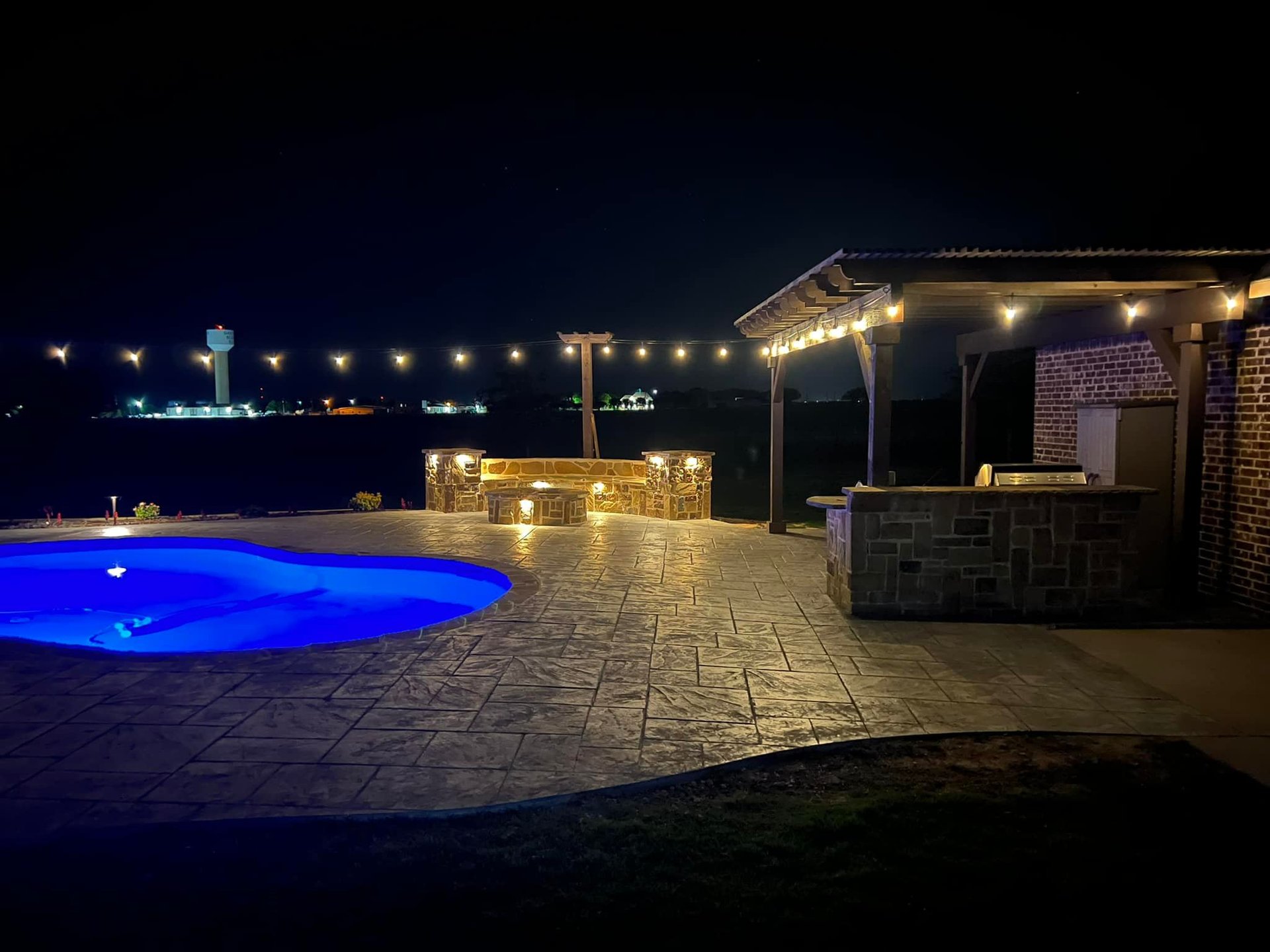 Outdoor Living Space at Night with Pool