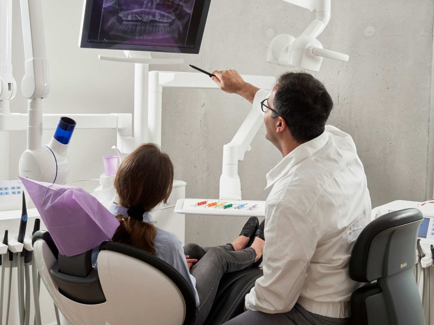 Dentist consulting with a patient in a modern Colorado Springs dental office