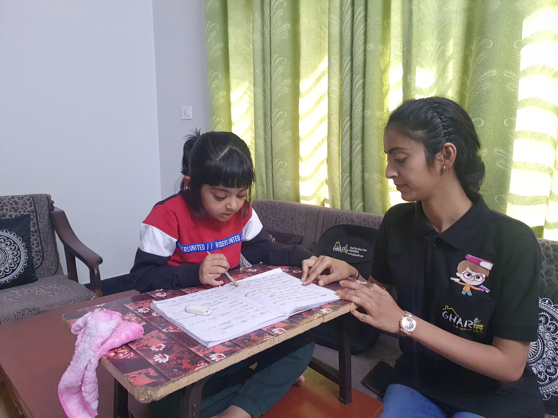 a home tutor from gharpadh teaching a student