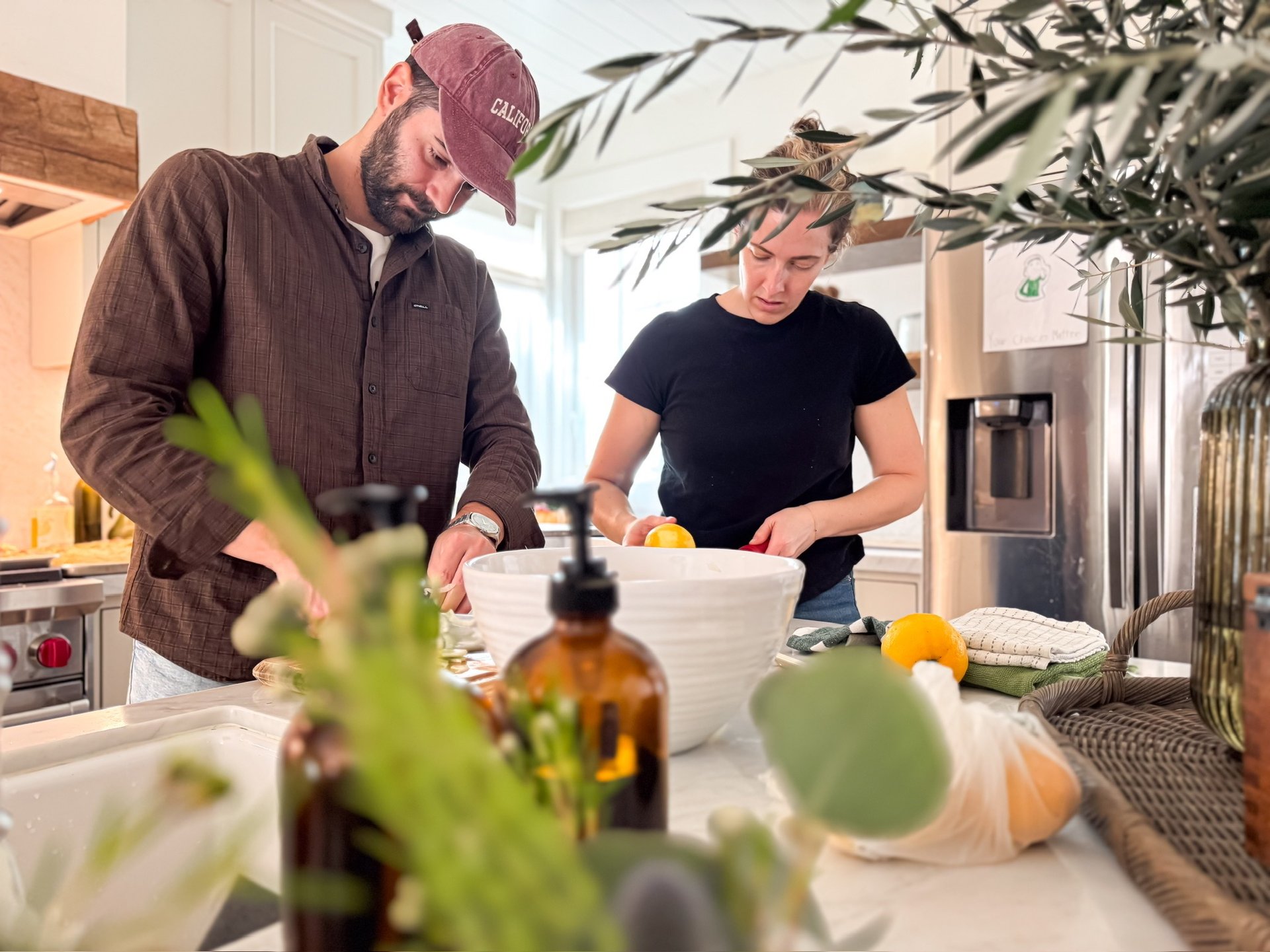 A man and woman preparing traditional Italian food in a home kitchen