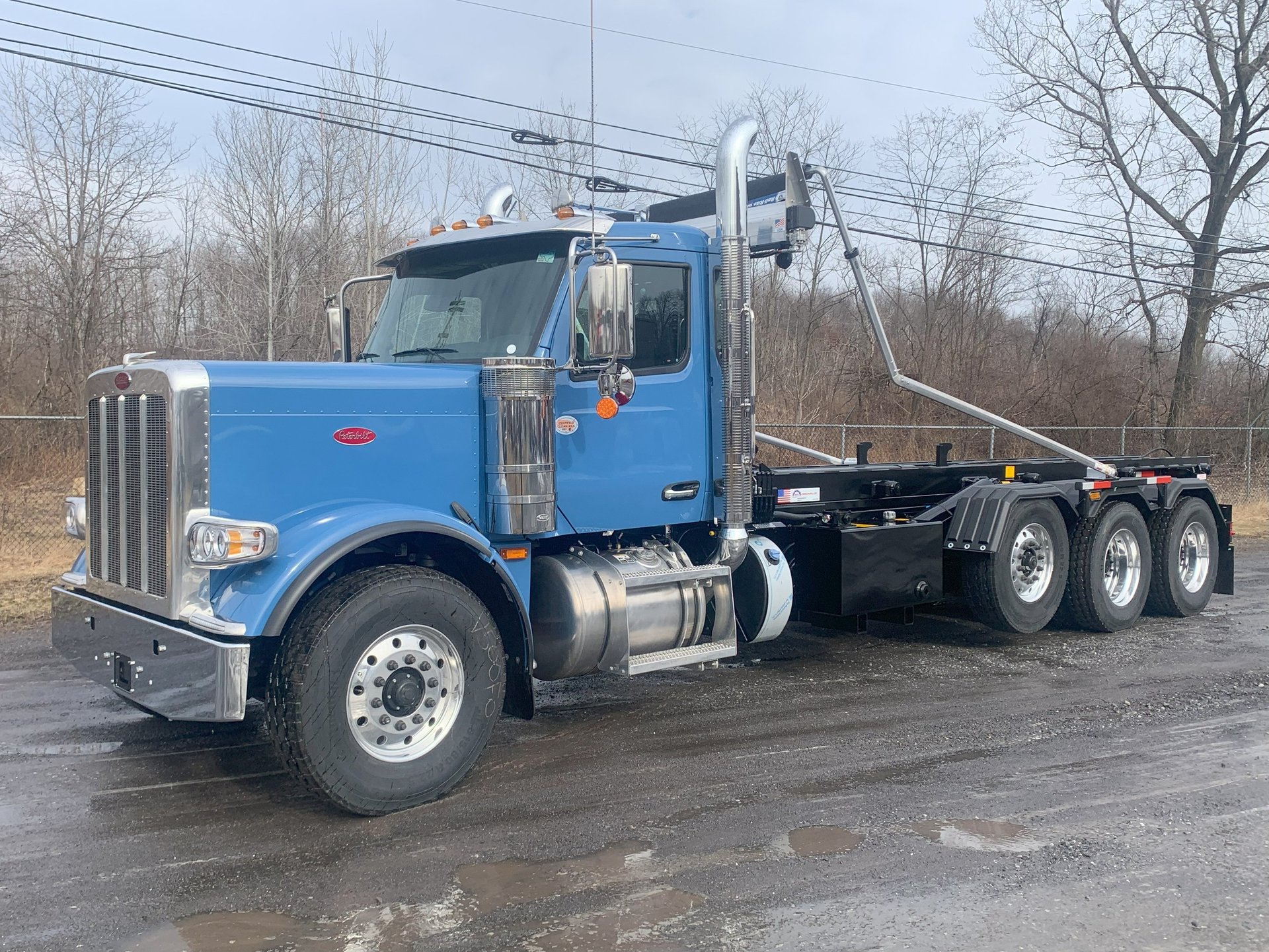blue Peterbilt roll-off truck
