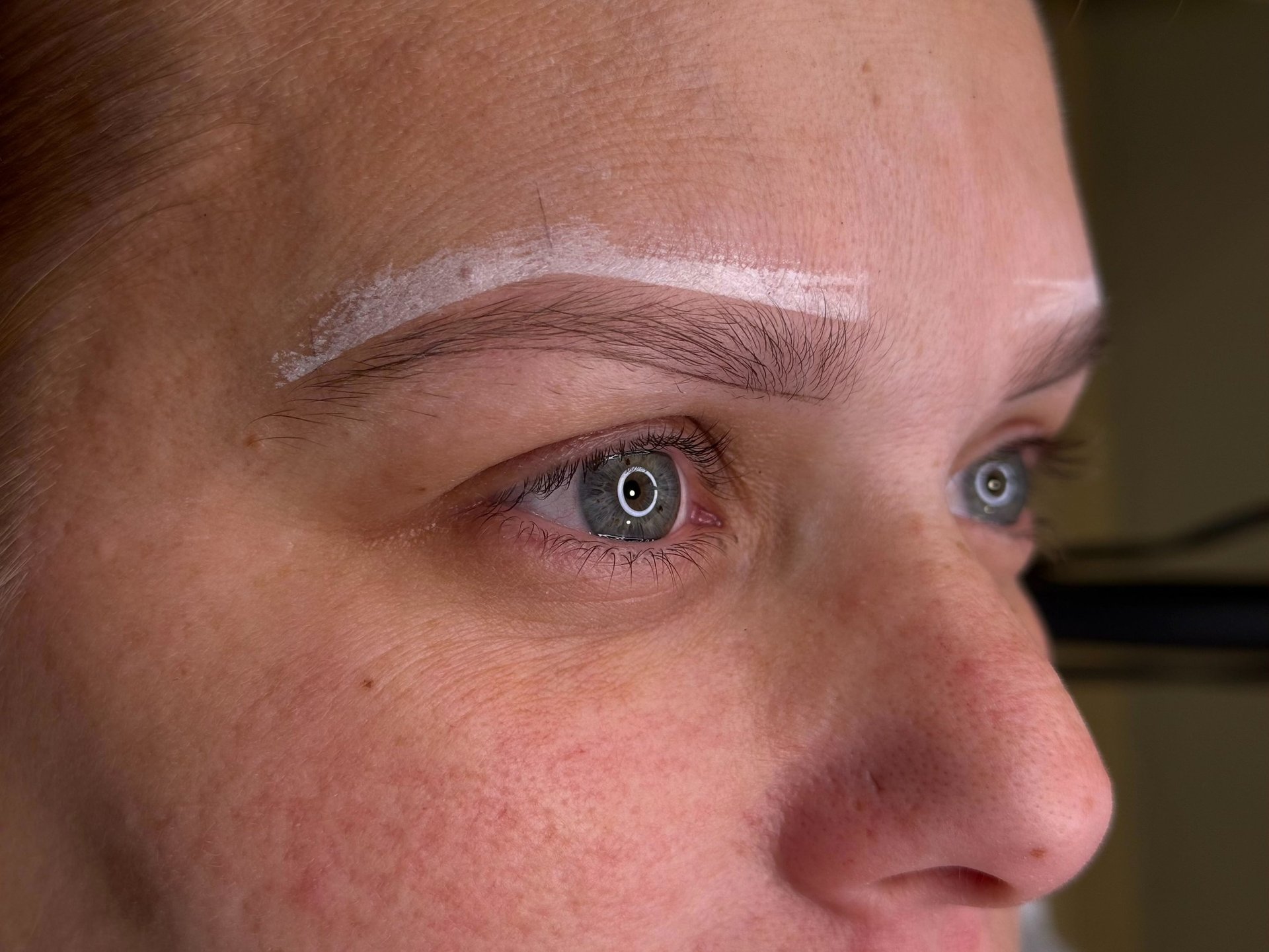 Woman after getting her eyebrows mapped by microblading master, ready for the procedure