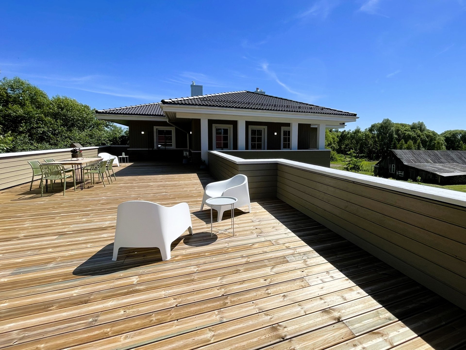 big sunny balcony terrace with furniture for dining and relaxing