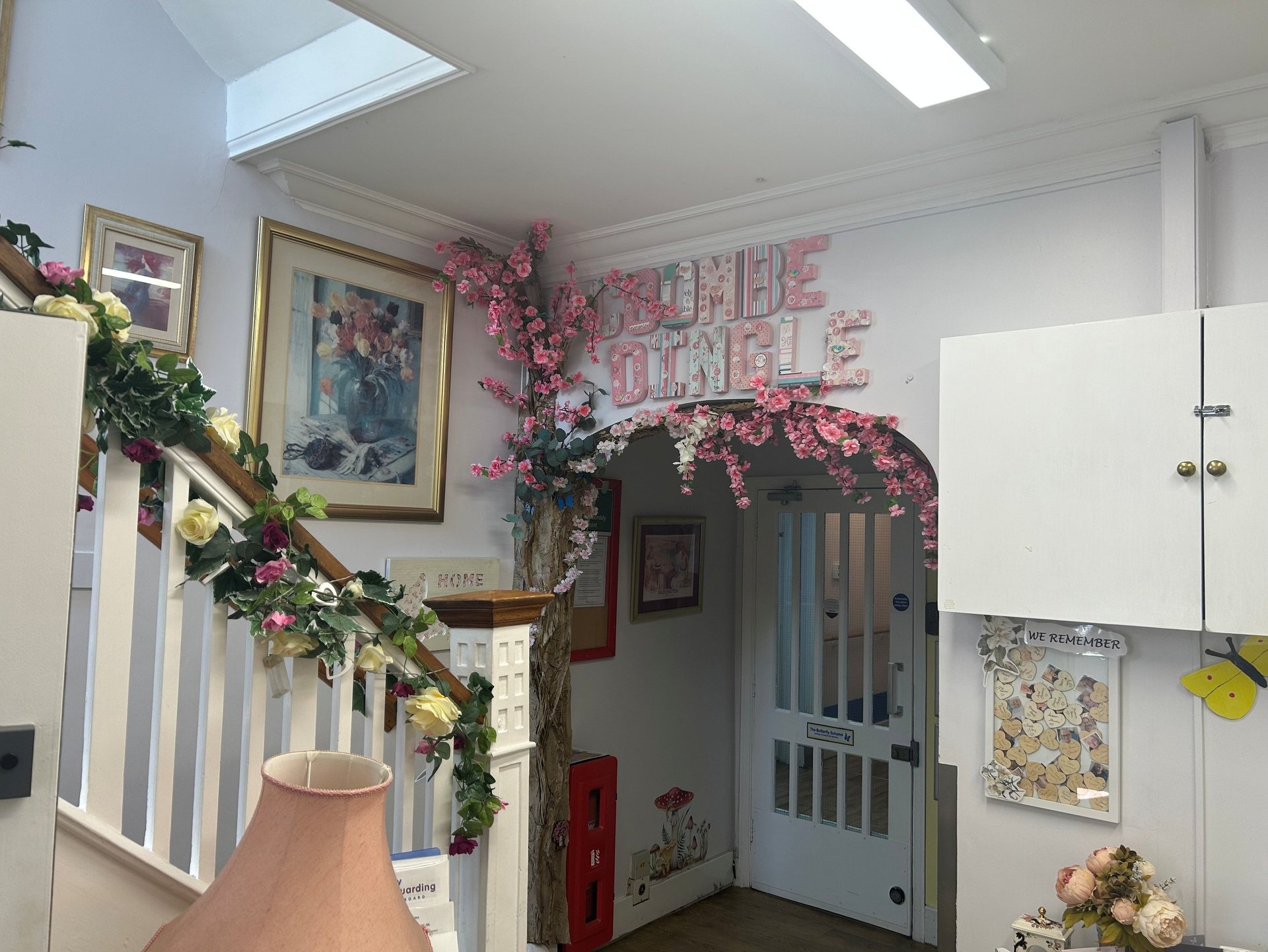 bright entrance hall with flowers along the stairs