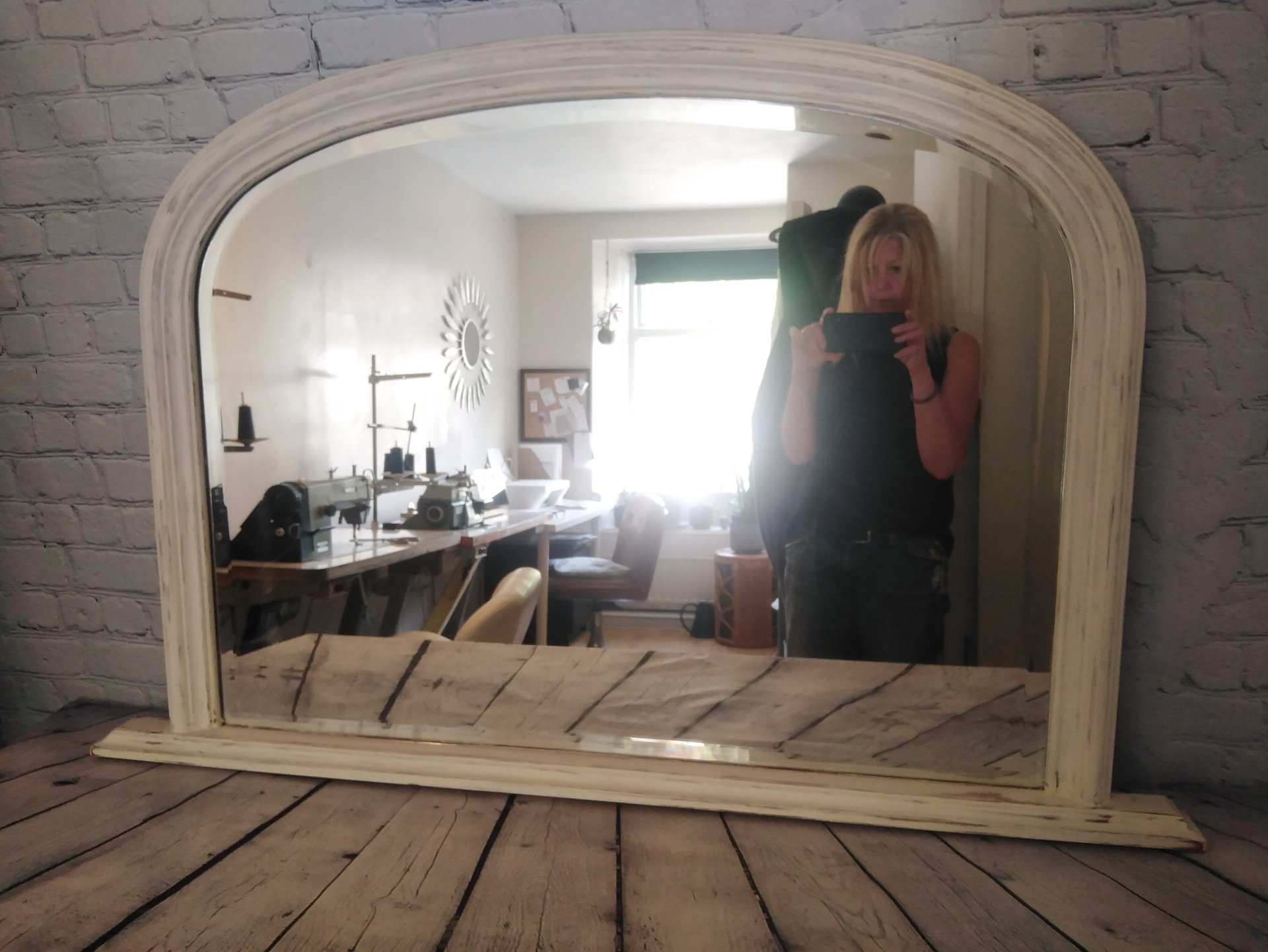 Lynn the owner of Hut Studio photographing art in the studio.