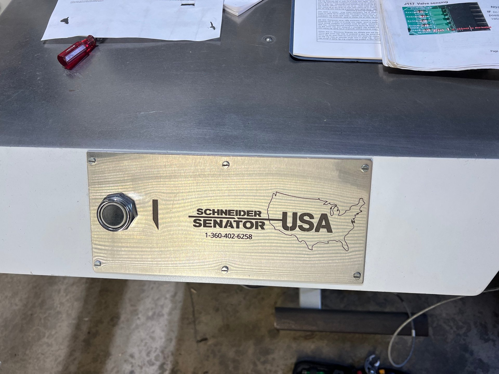 Stainless steel cut button cover for industrial paper cutter with cutouts for cut button and screws