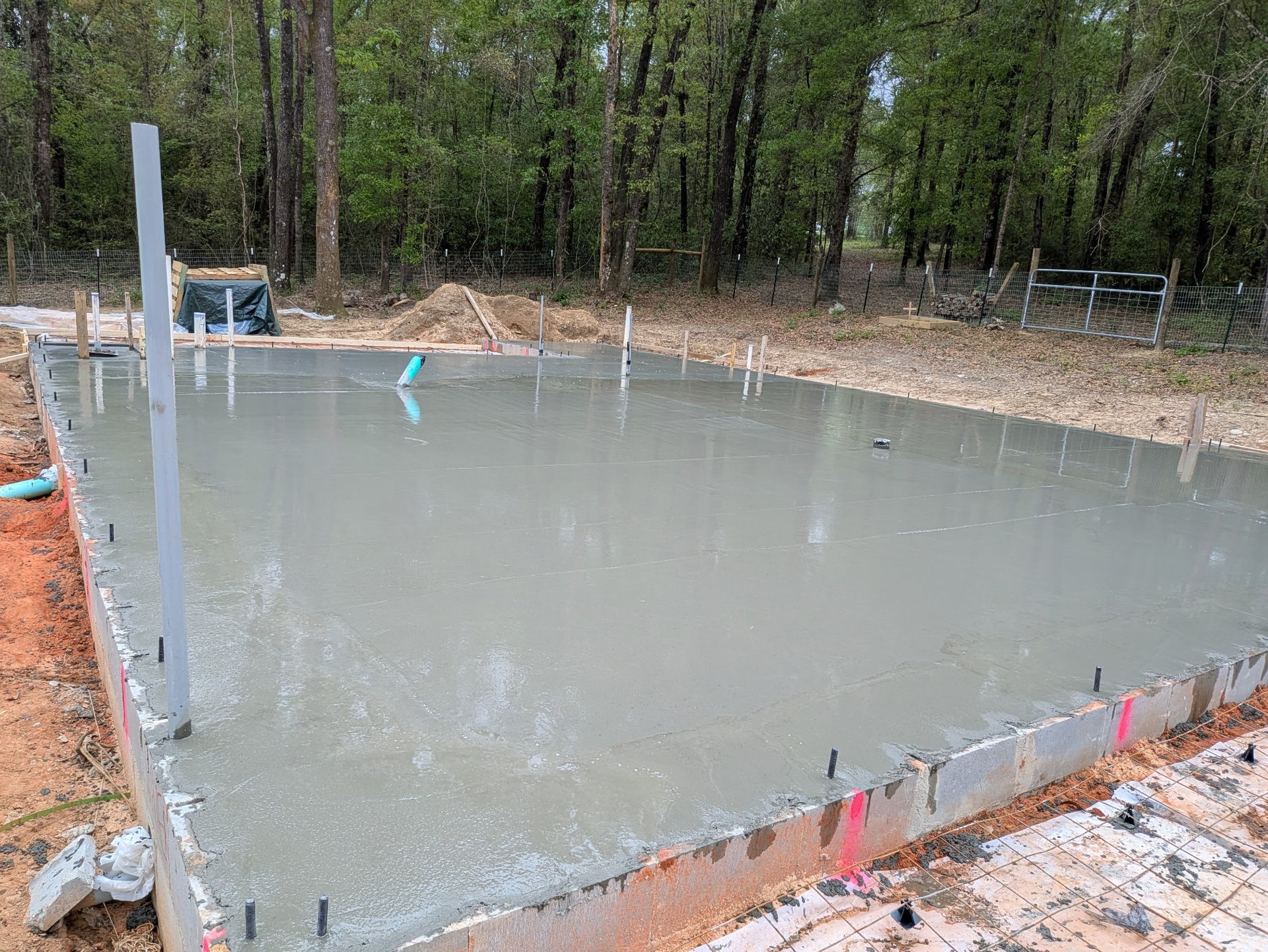 Concrete slab installation in Pensacola FL with fresh poured concrete and reinforced edges