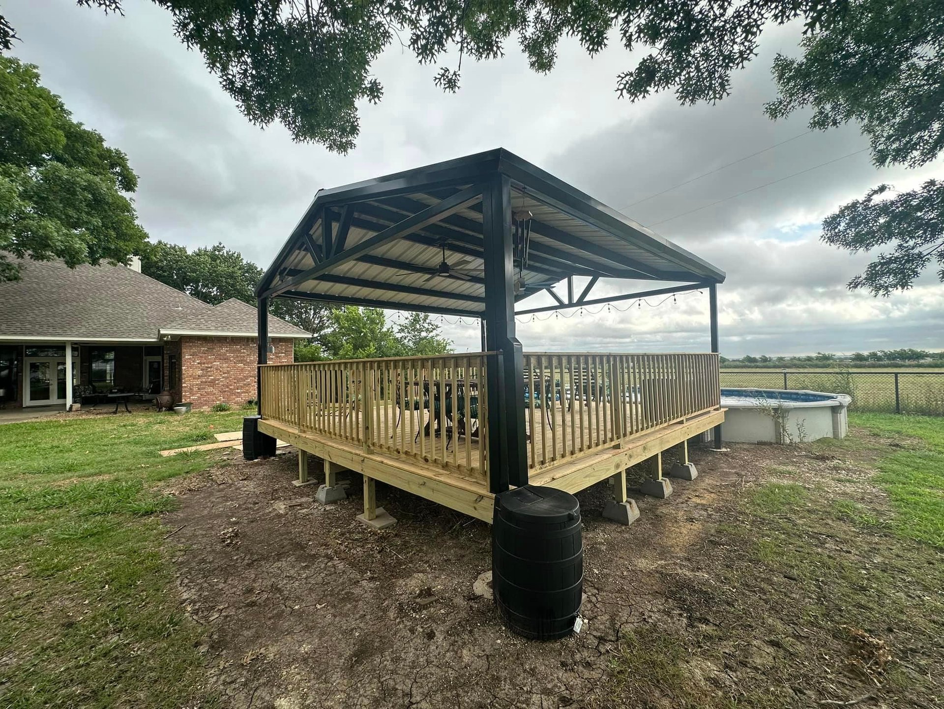 Black Metal Patio with Wood Deck and Pool