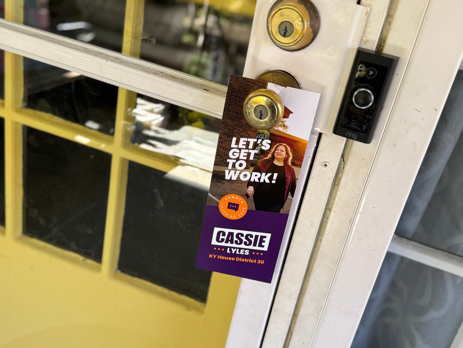 a door handle latched door with a sign that says let's get off