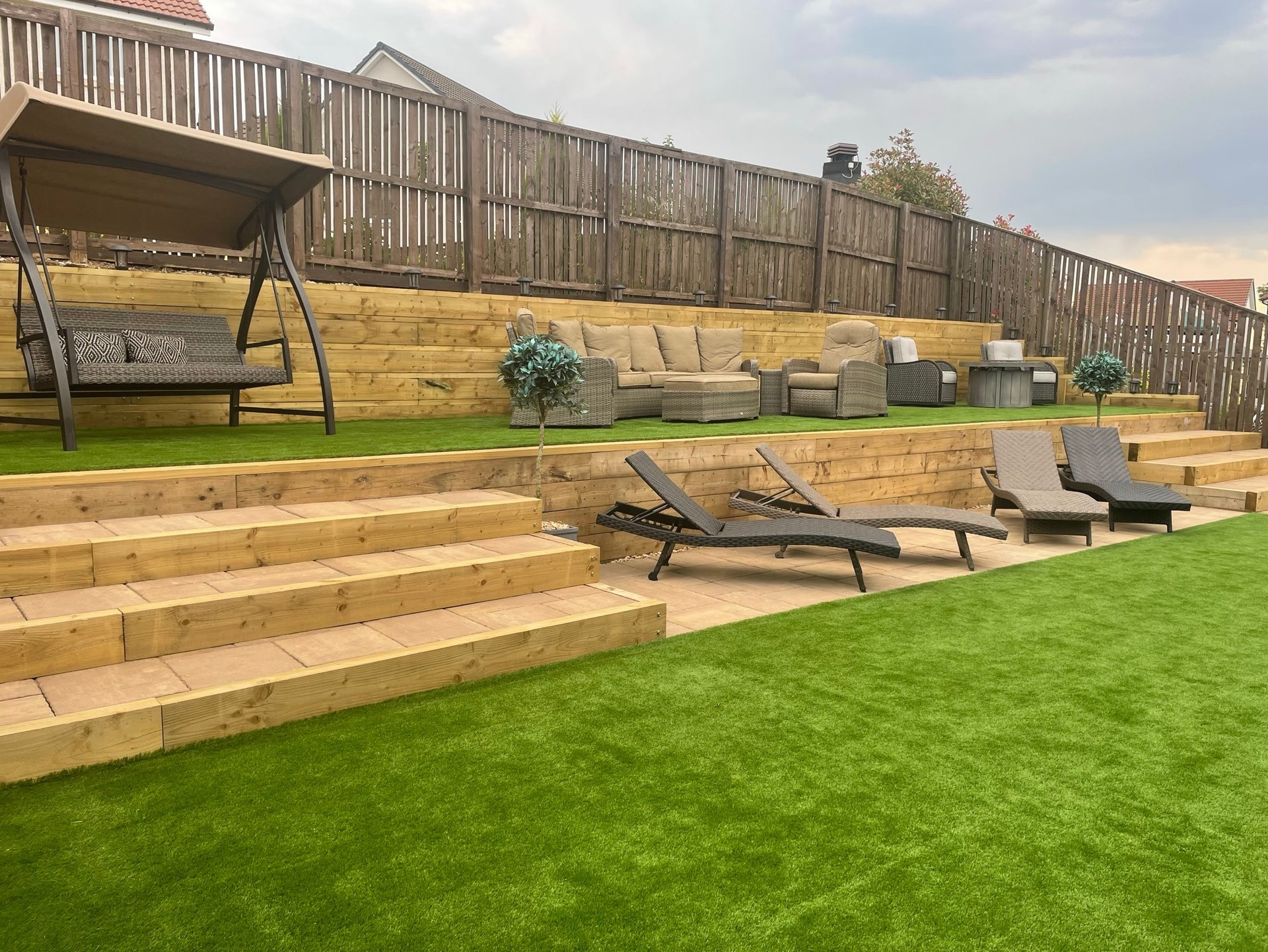 Garden with oversized stairs and double height retaining wall.