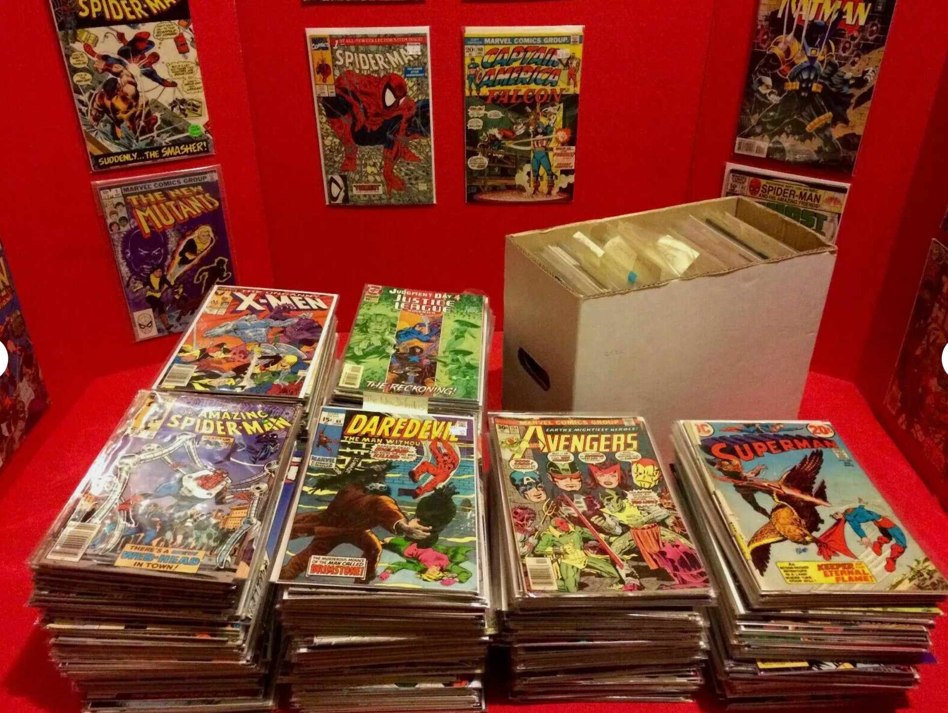 a table with a lot of comics books and comics