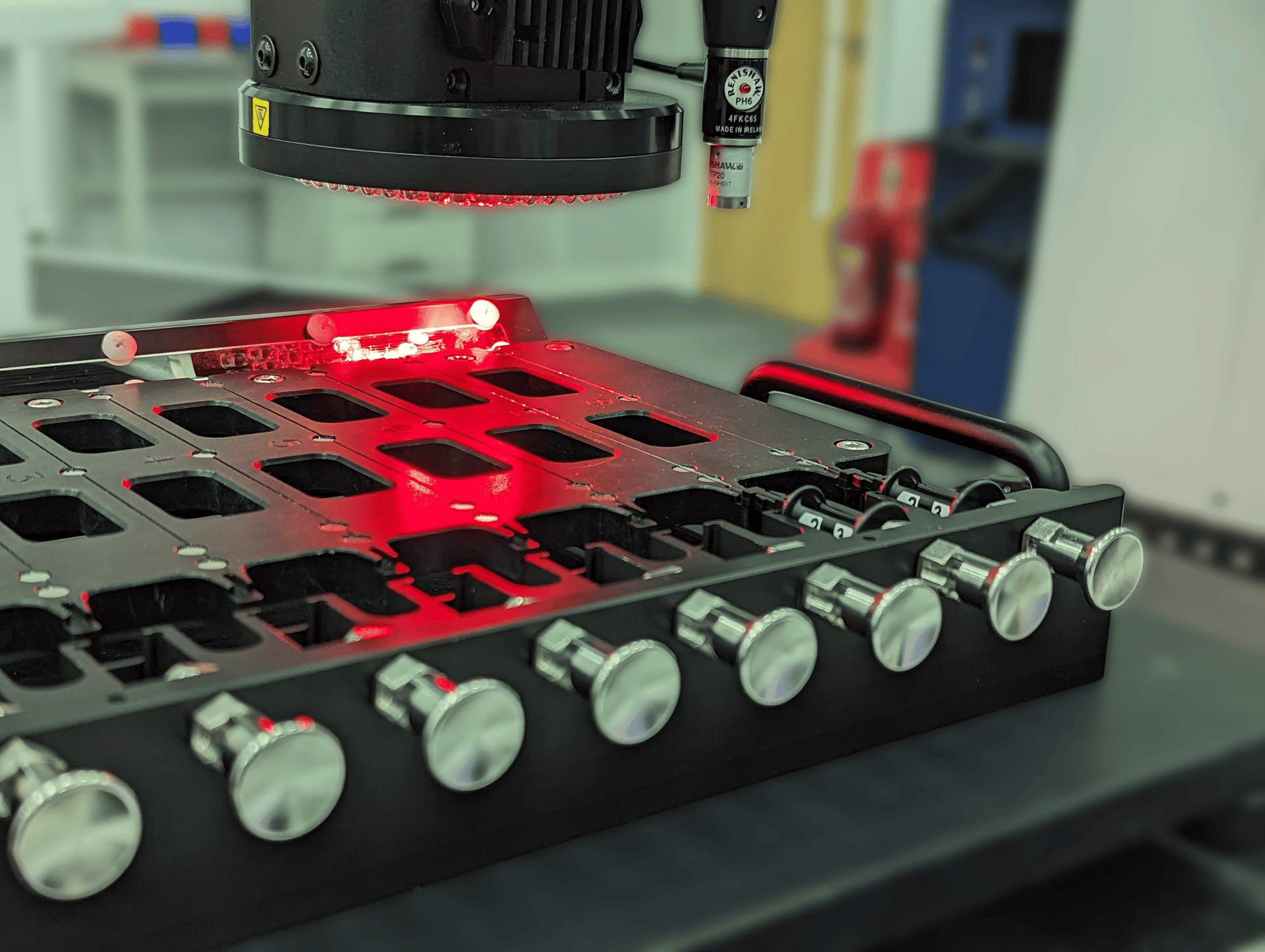 Multi-nest metrology fixture holding small thin medical devices whilst being inspected by an optical CMM.