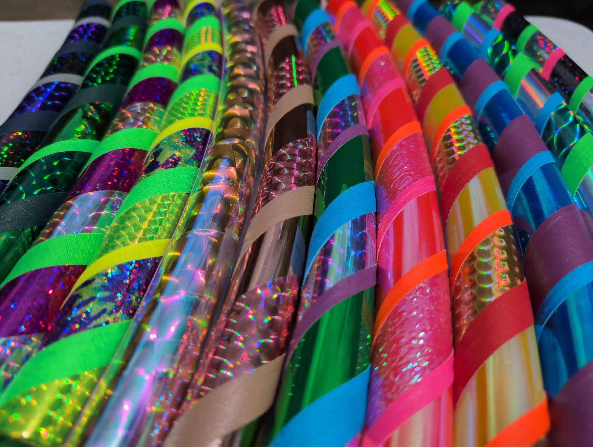 Vibrantly colorful hula hoops tapes with a variety of shiny, prismatic, iridescent tapes