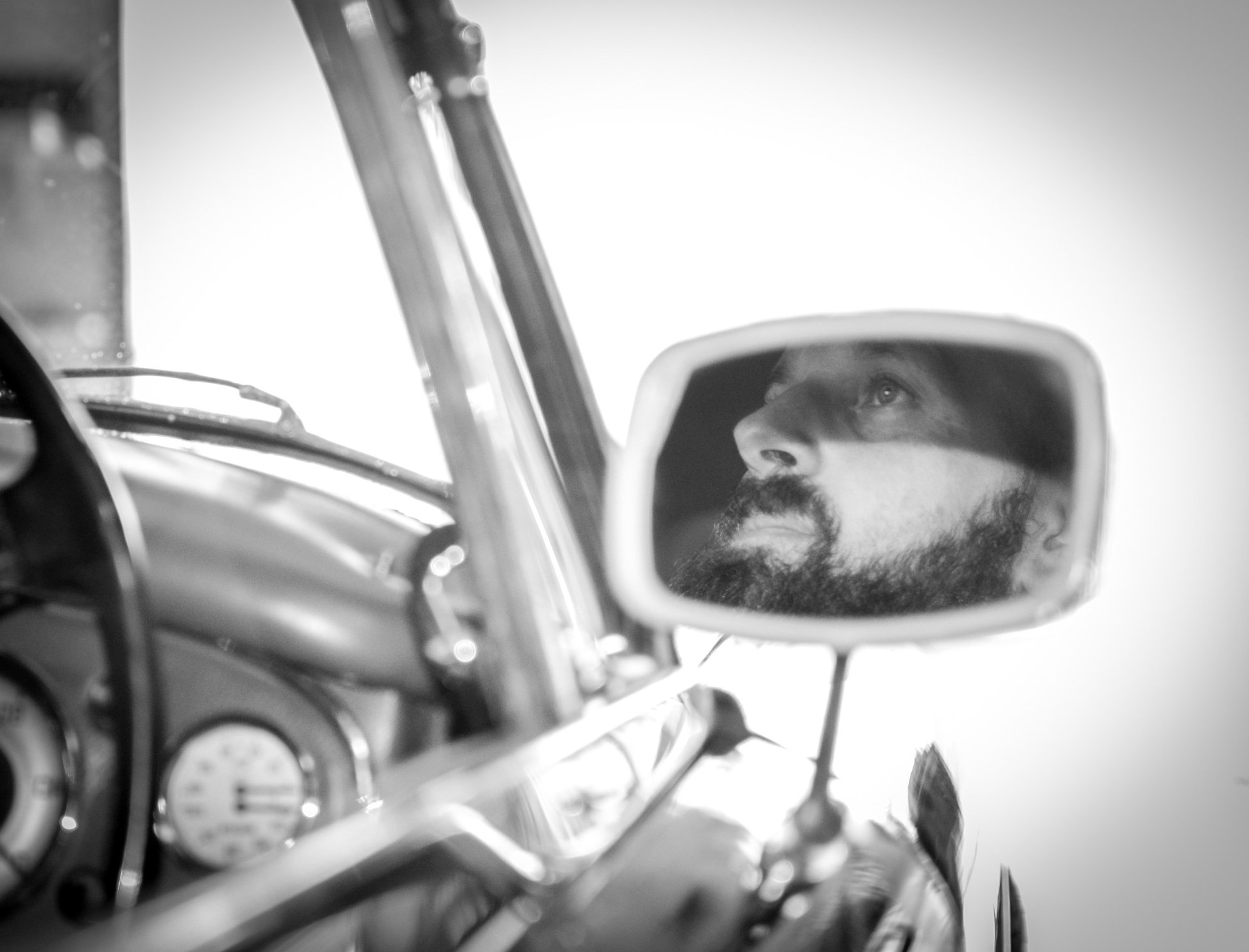 a man with a car and a car in a mirror