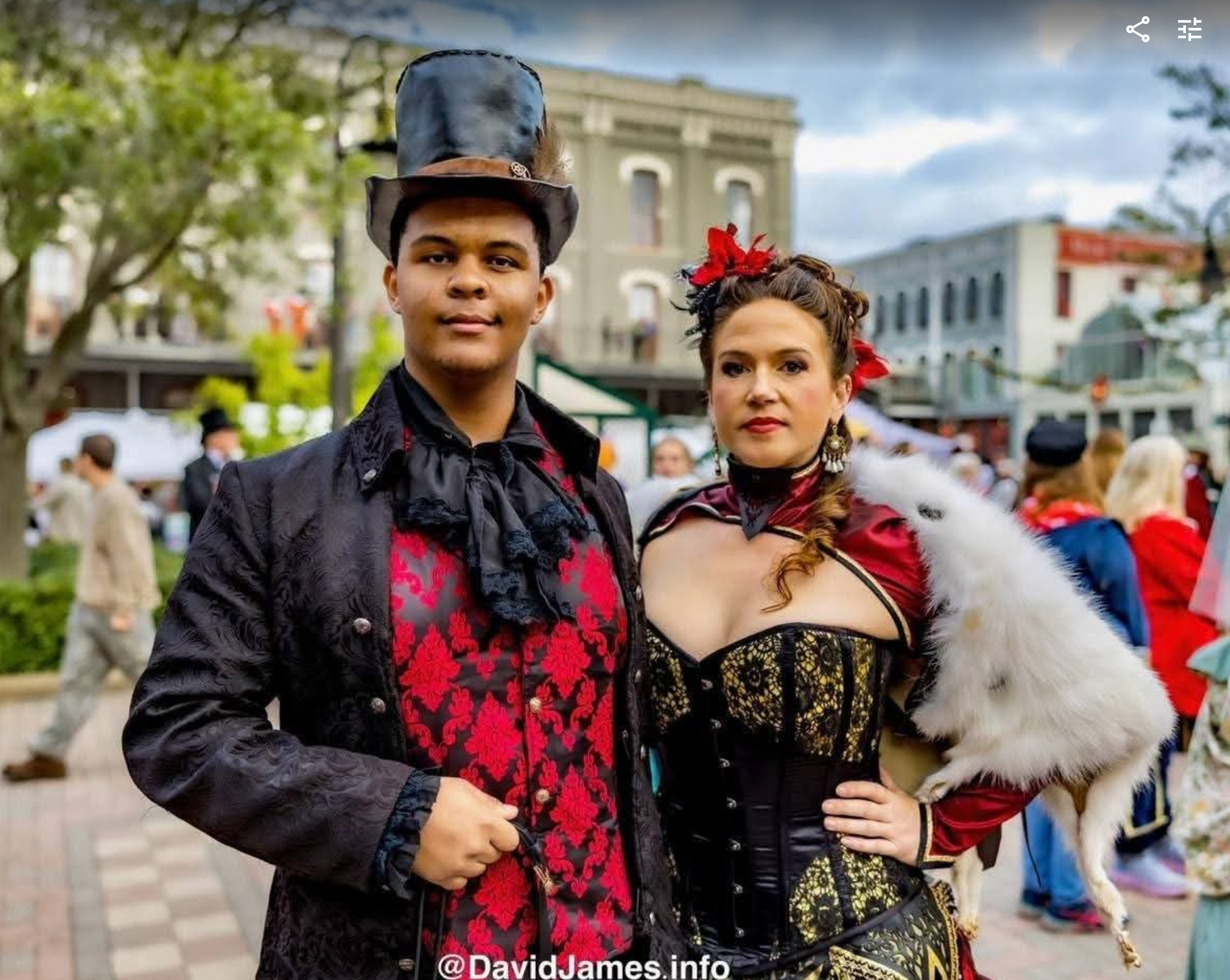Justin Cale II and Overslady in Victorian Garb with a top hat and corset at a dickens on the strand