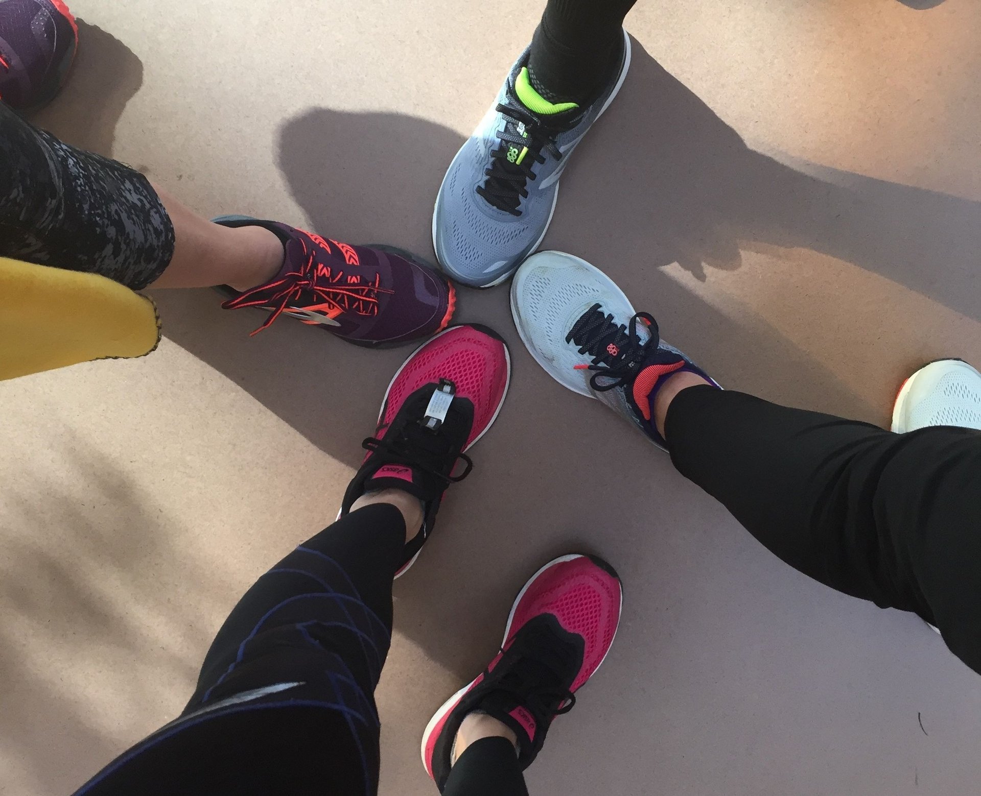 a group of people standing in a circle with their feet on the ground
