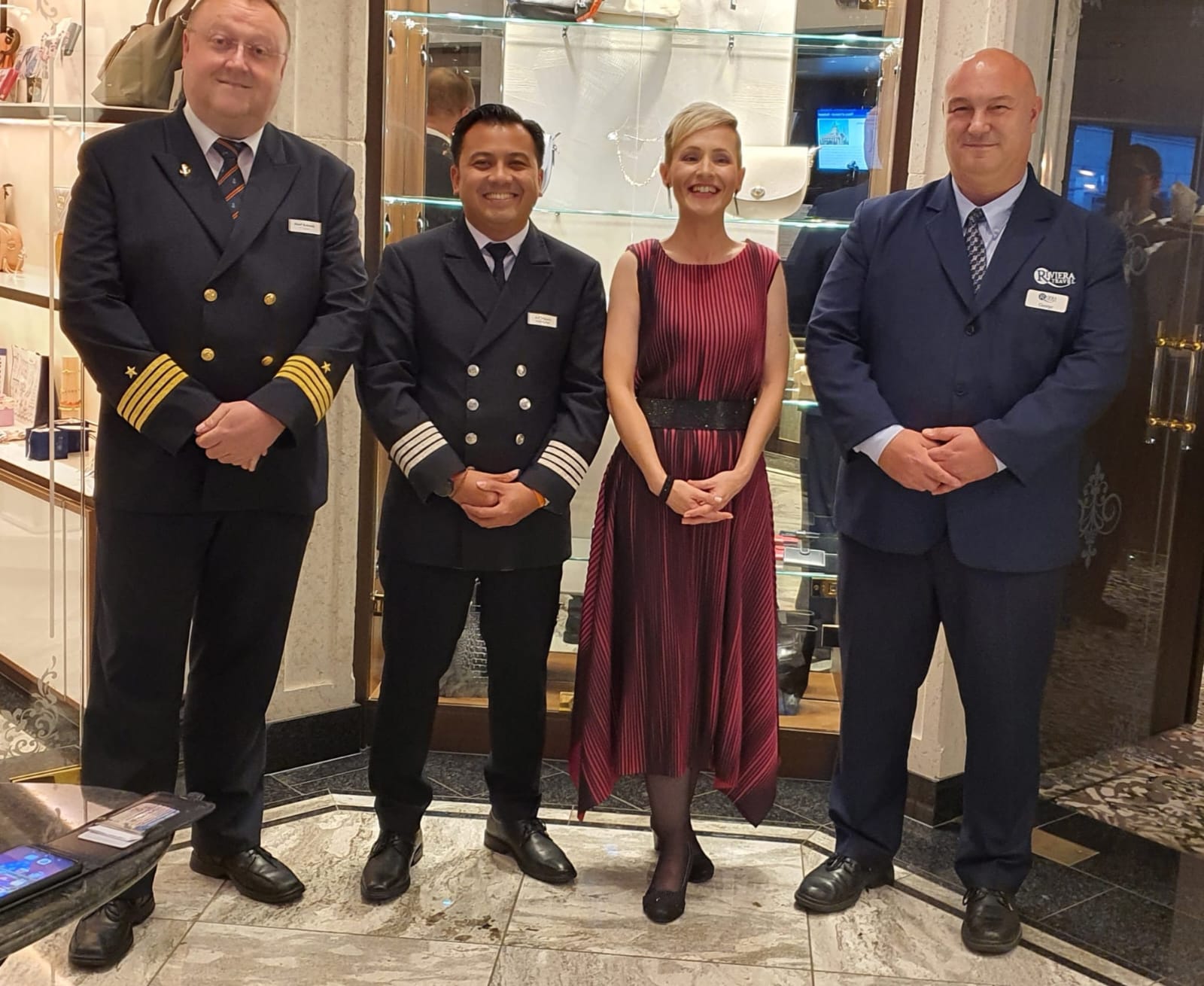 Managerial river crew posing in formal uniforms.