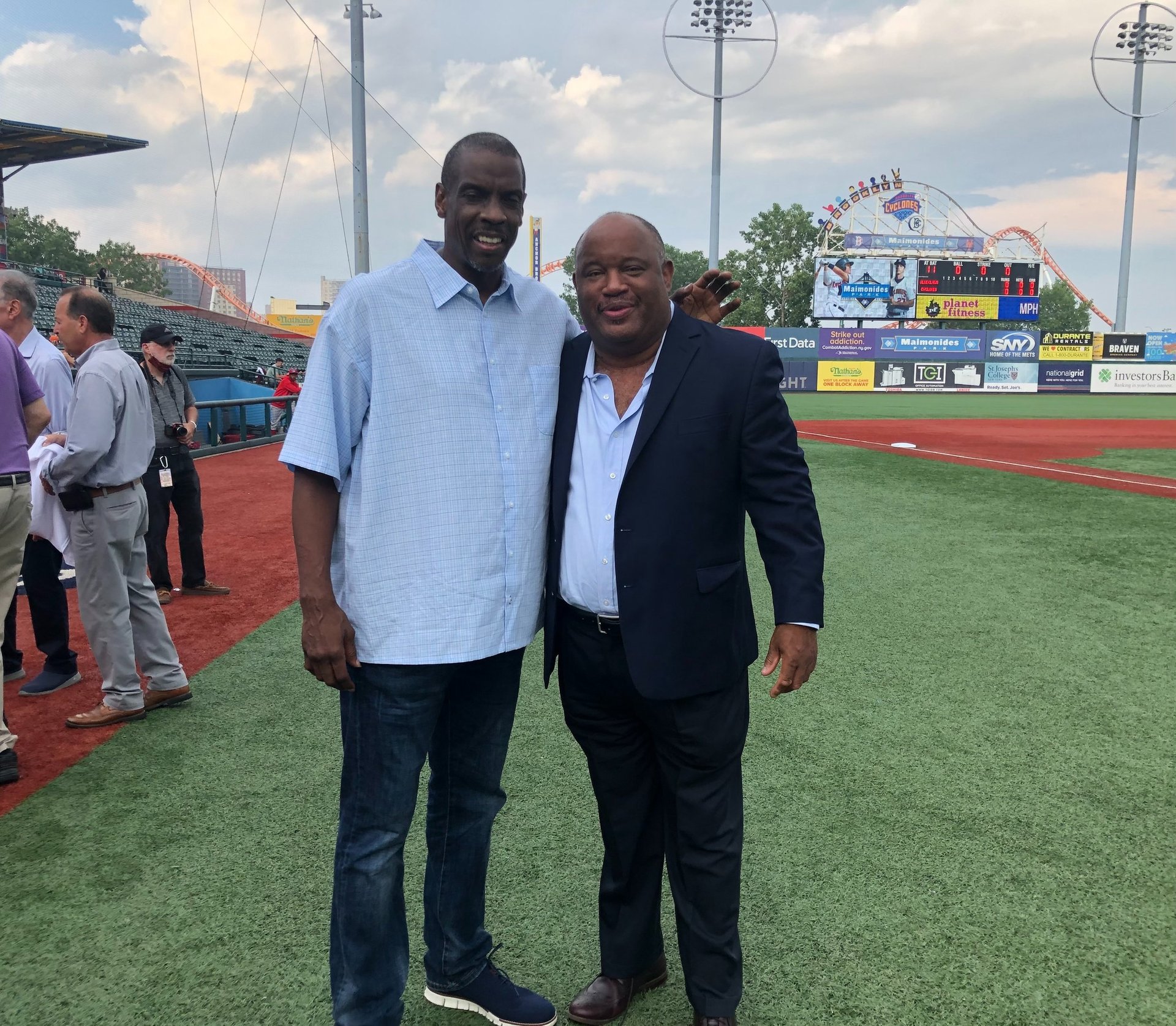 Dominic Carter, author and keynote speaker, with NY Mets legend Dwight Gooden on a baseball field.
