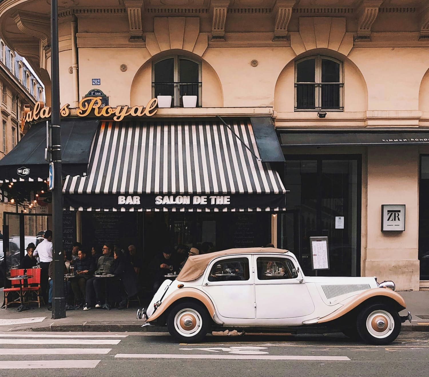 Picture mediterranean atmosphere of a vintage car in front of a Bar