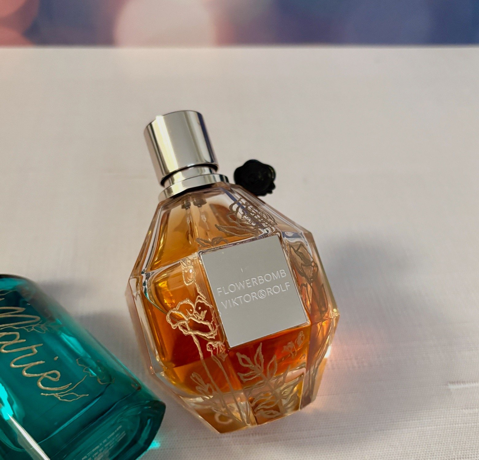 bottle of Flowerbomb perfume with hand engraved flowers that are filled with gold