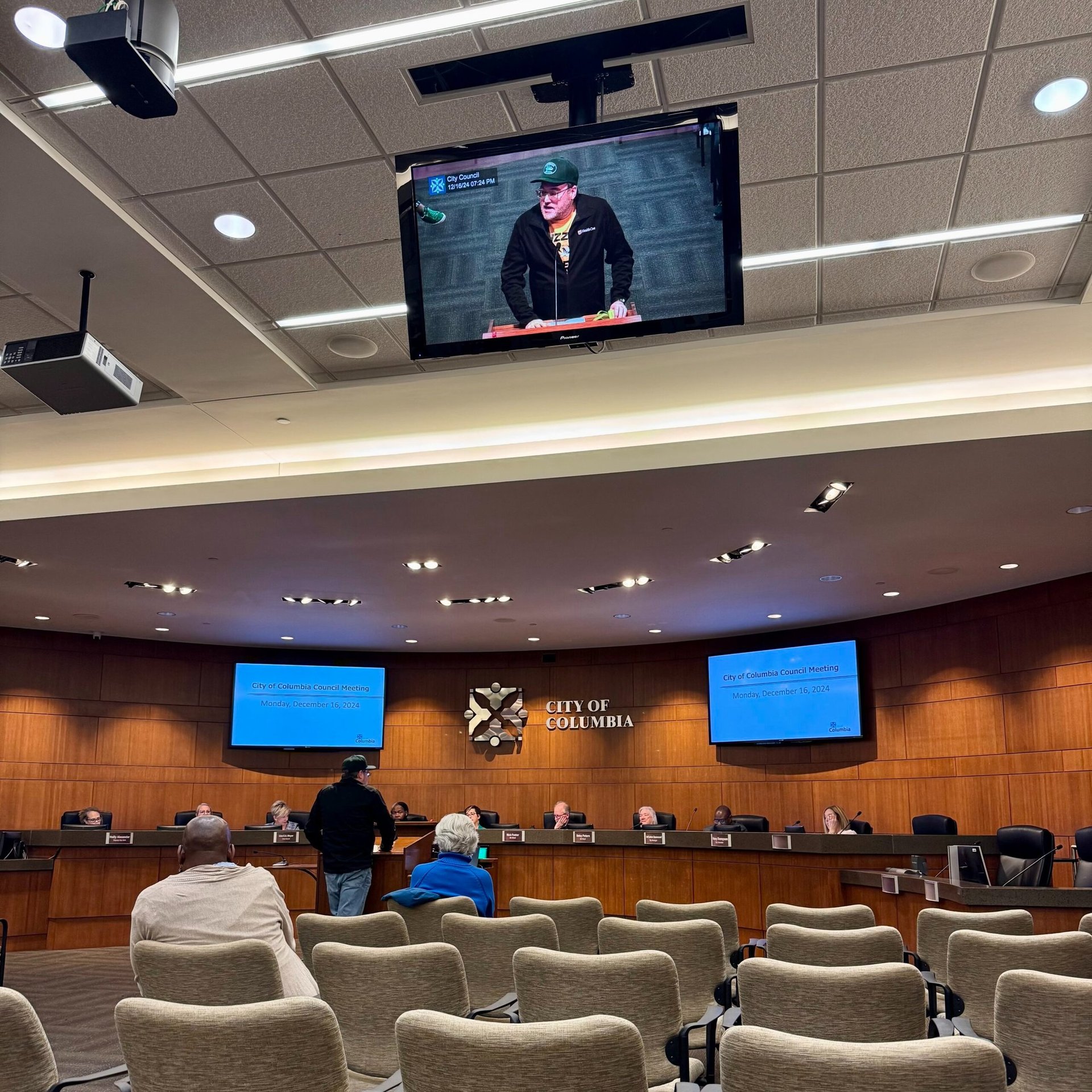 Man standing at the podium before city council.