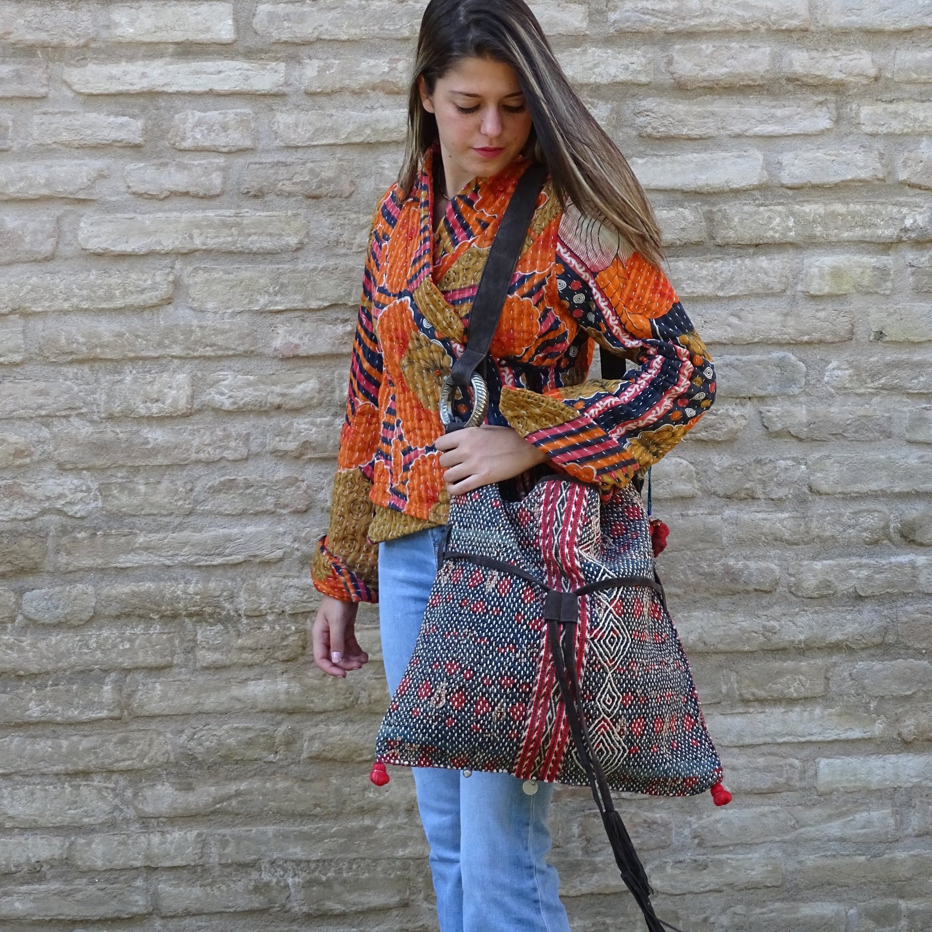 modella che indossa una borsa realizzata con un antico tessuto tribale