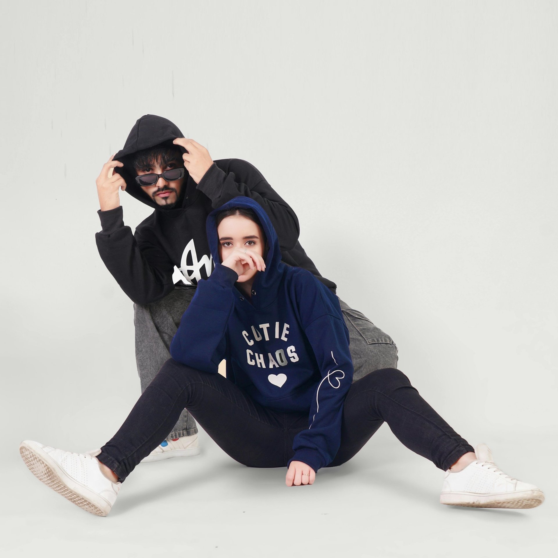 2 people wearing customized hoodies