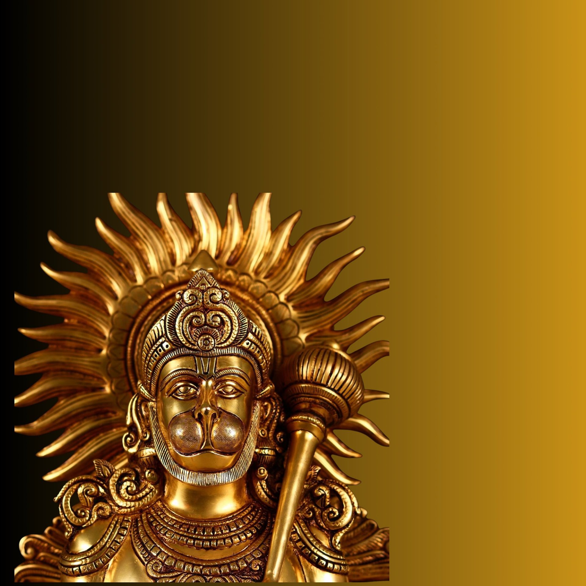 a brass statue of a hanuman with a sword