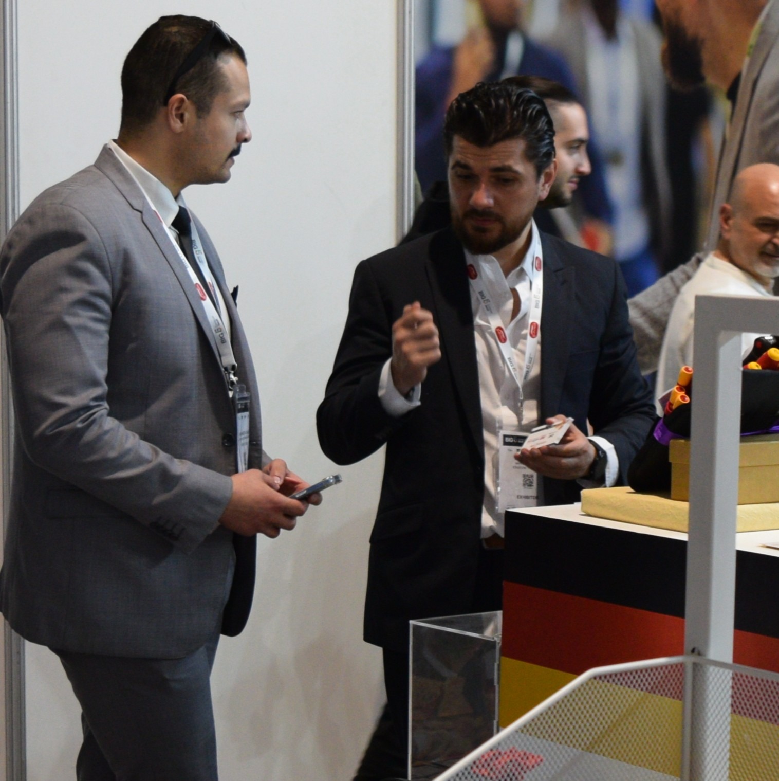 a man in a suit and tie is talking to a man in a suit