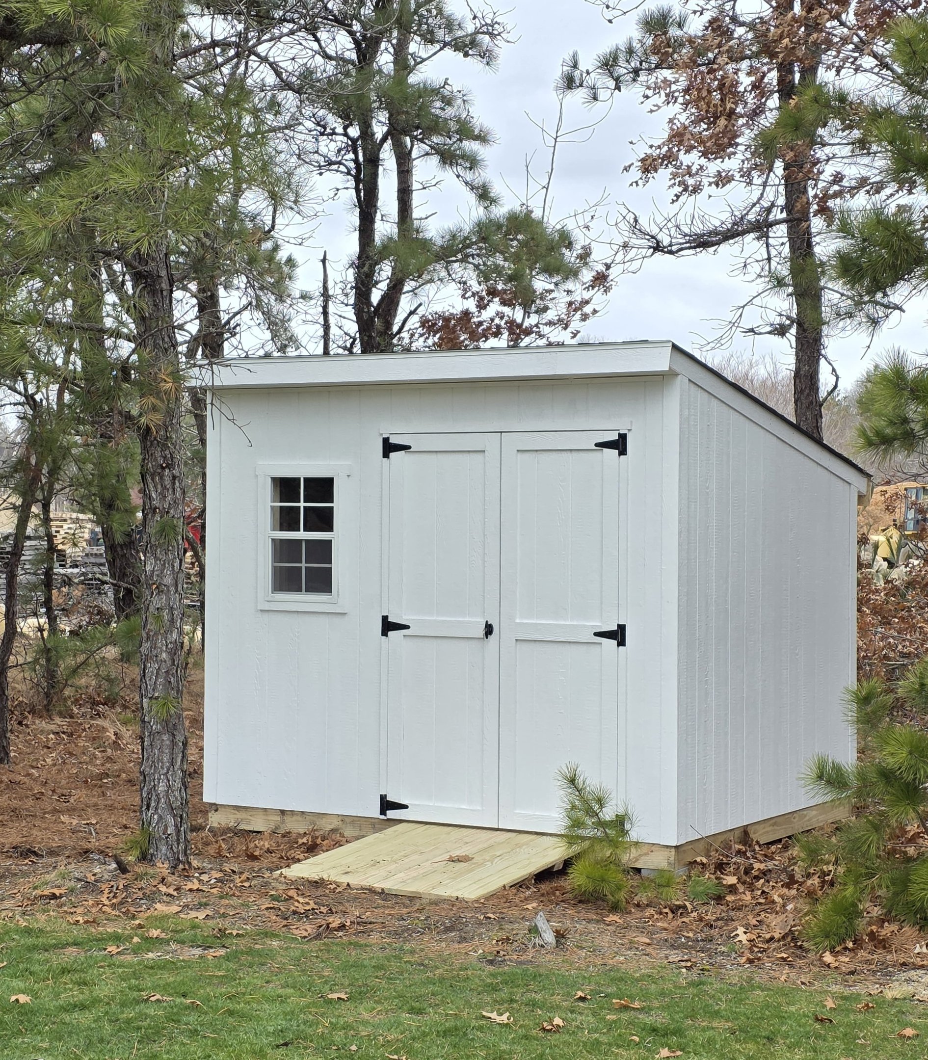 Custom-built 6x8 wooden shed with window, handcrafted in Halifax, Massachusetts for small outdoor spaces.