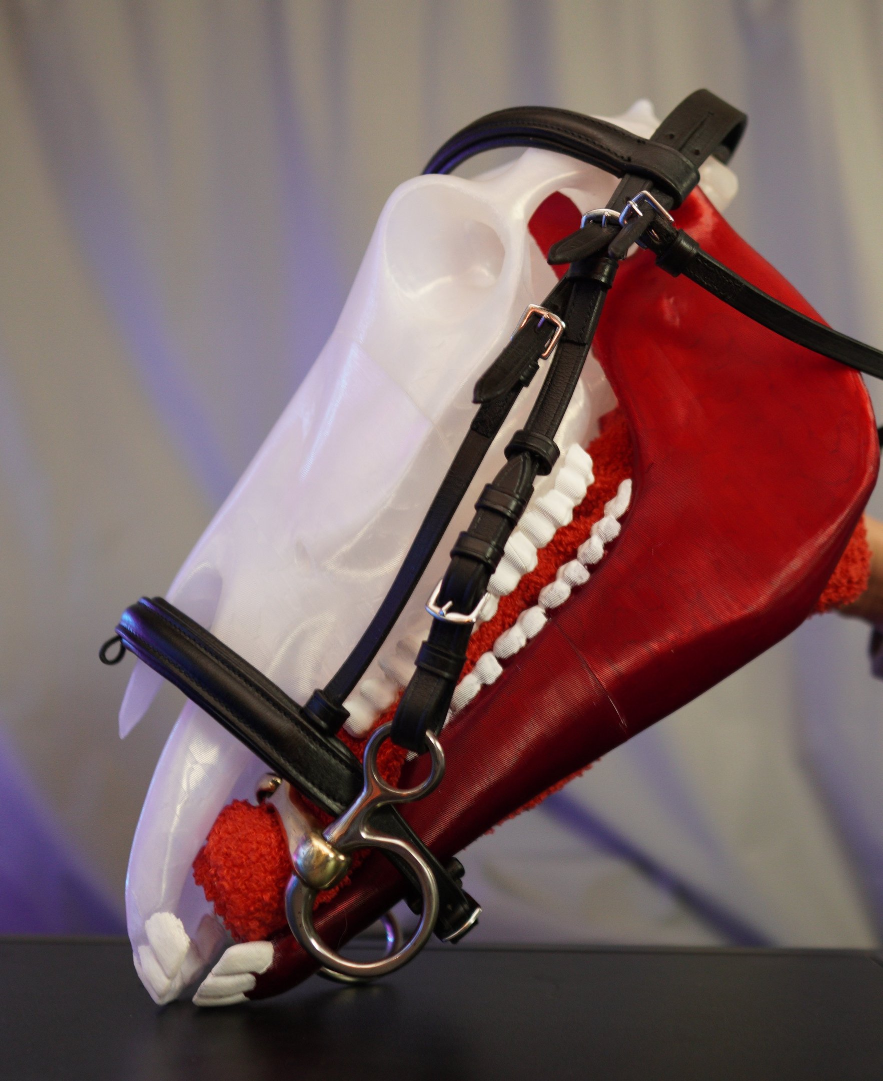 a horse with a red nose and white teeth