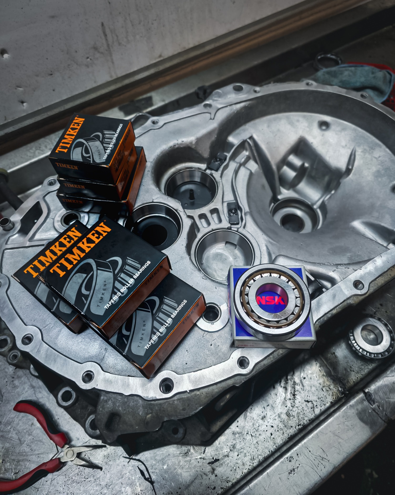 New Timken tapered roller bearings and NSK resting on an aluminium transmission housing