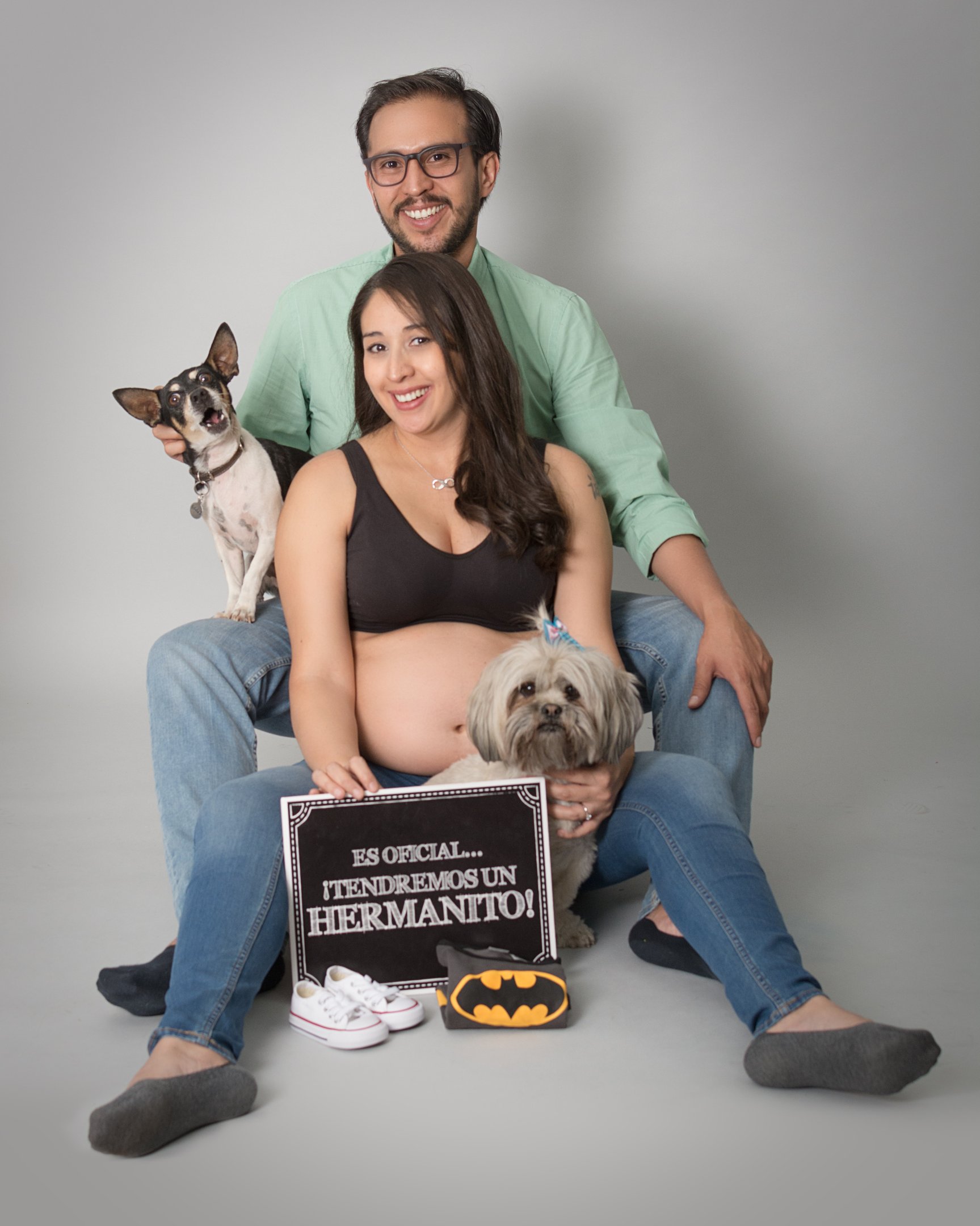 a pregnant woman and her husband are posing for a photo